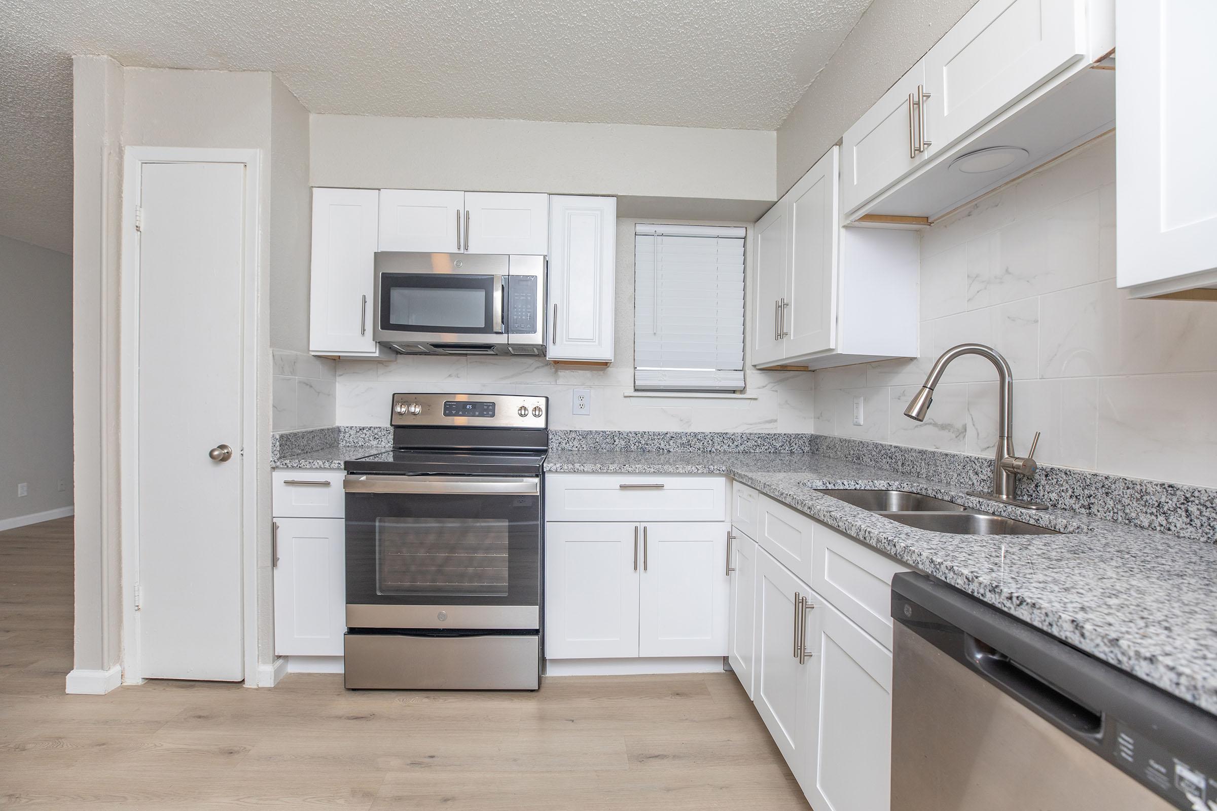 a kitchen with a stove top oven sitting inside of a refrigerator