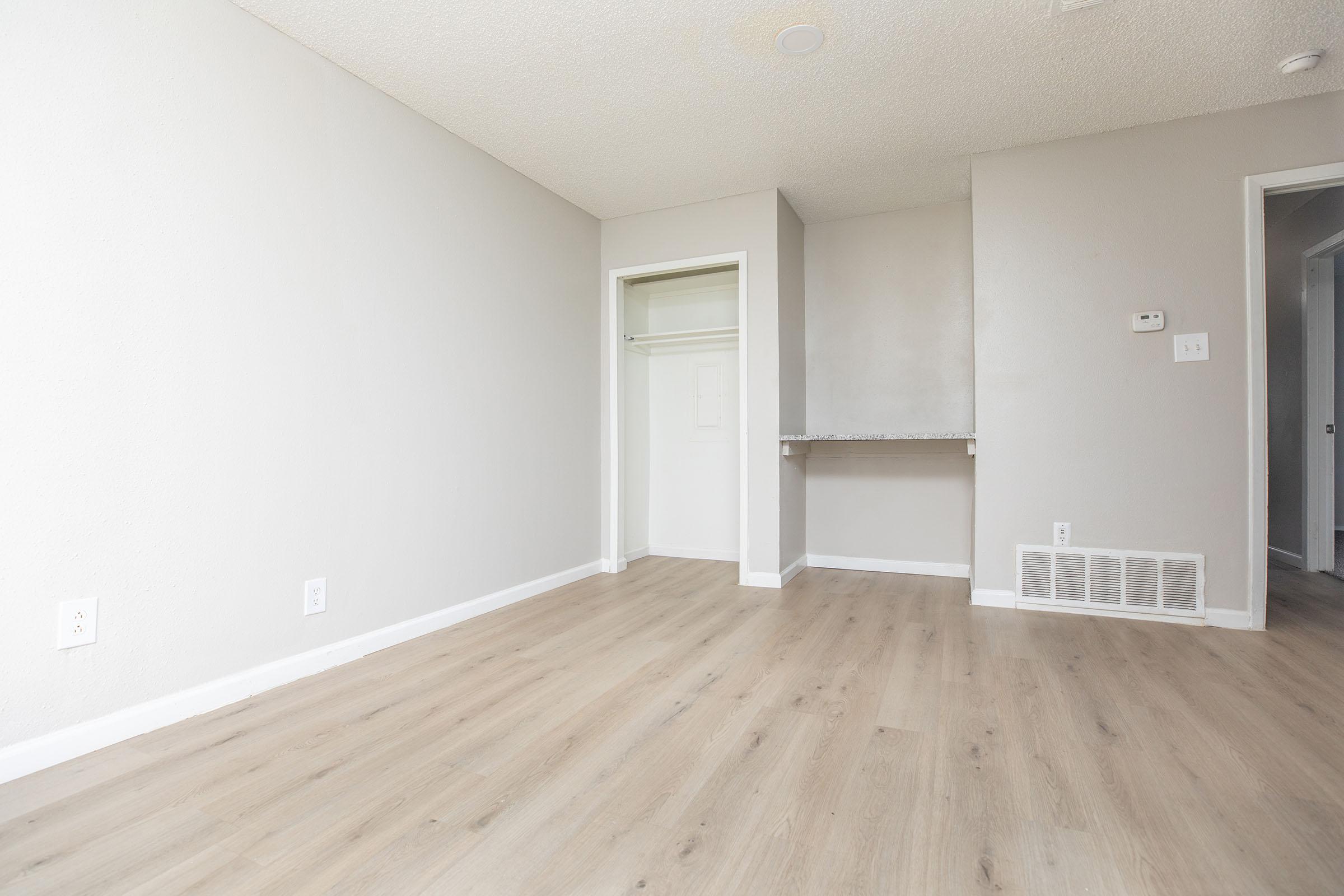 a large empty room with a wooden floor