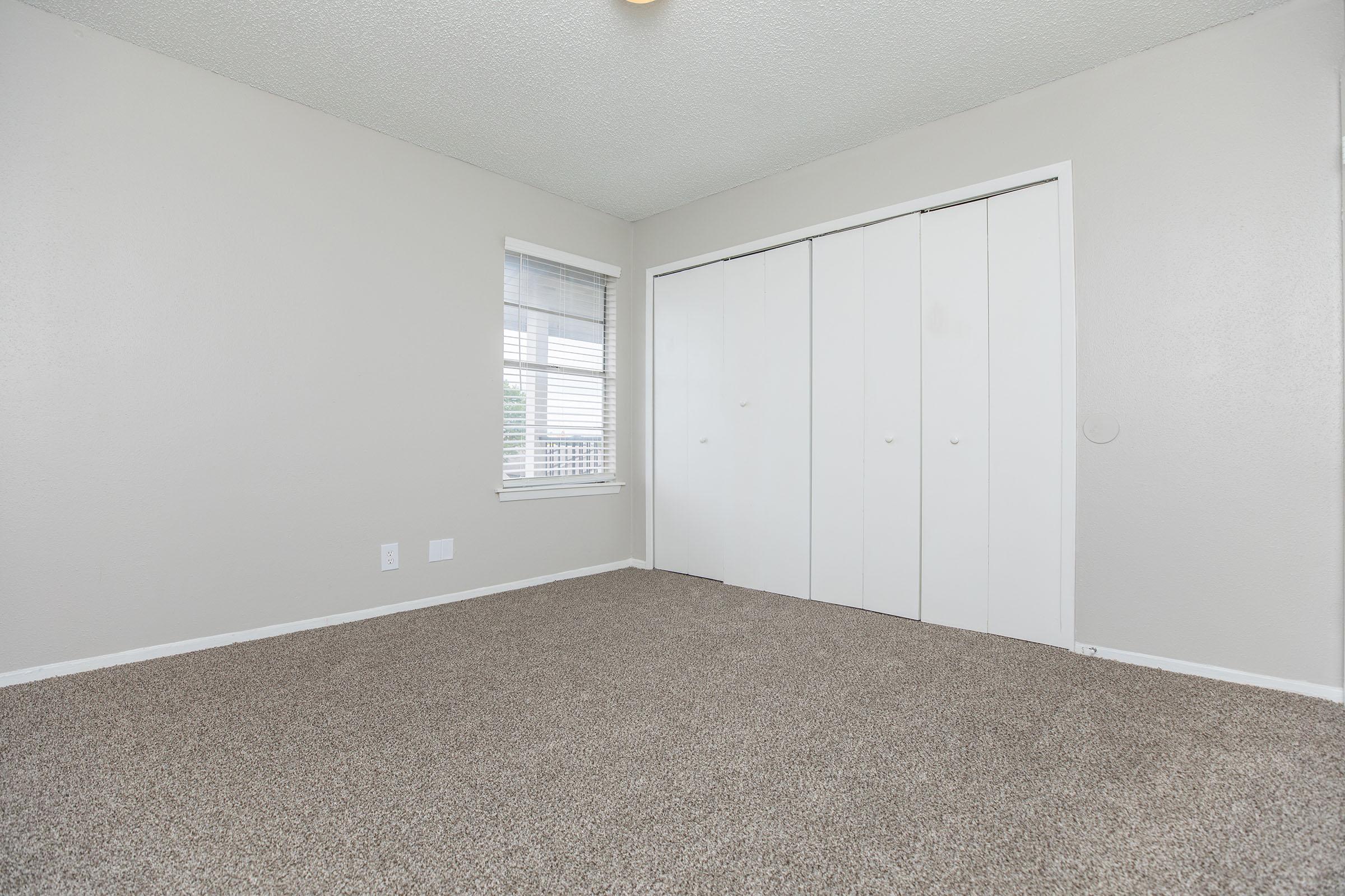 a bedroom with a large window