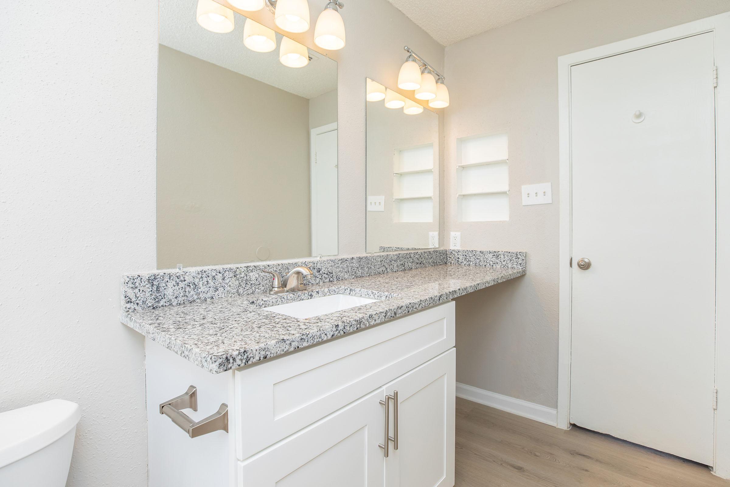 a kitchen with a sink and a mirror