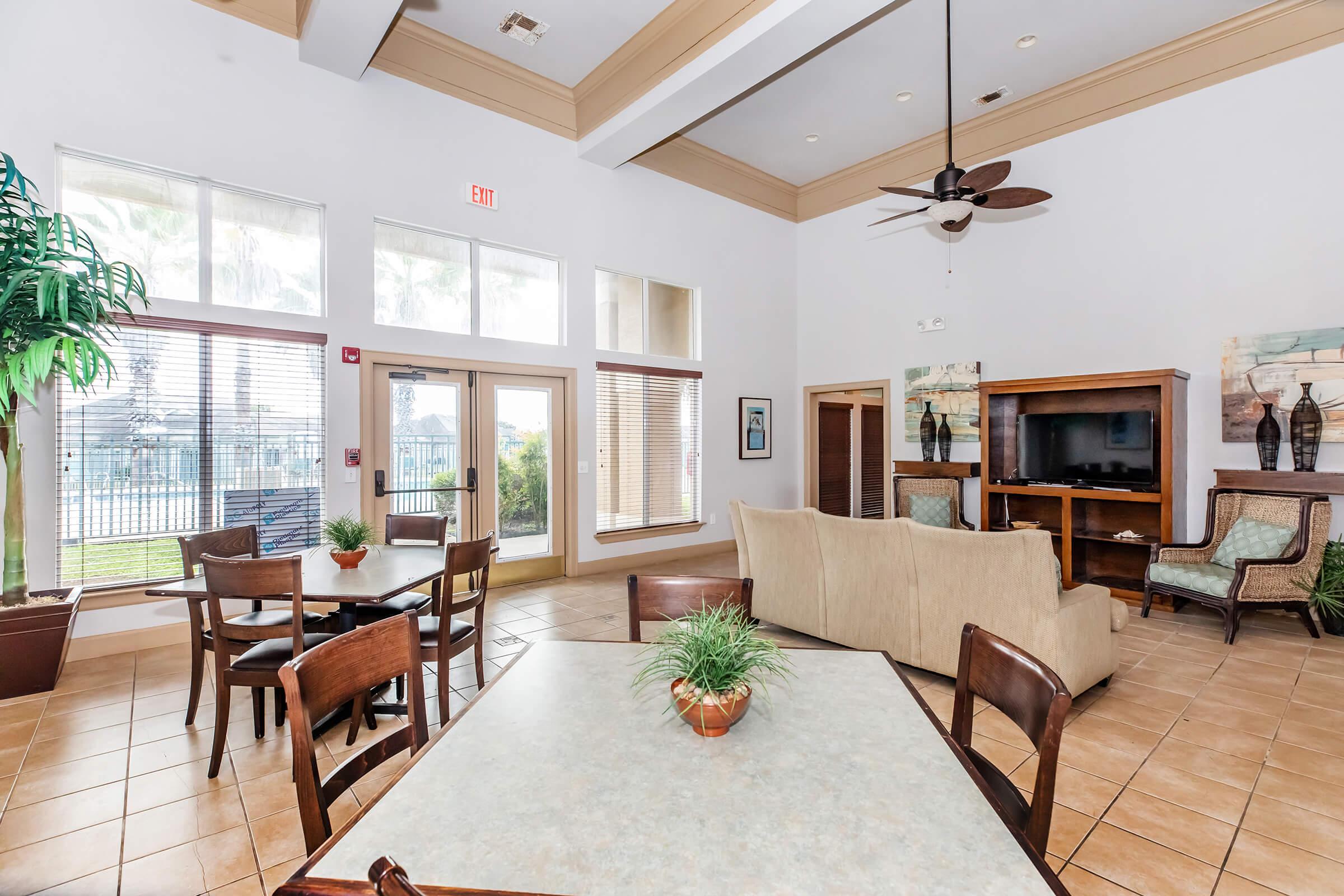 a living room filled with furniture and a large window