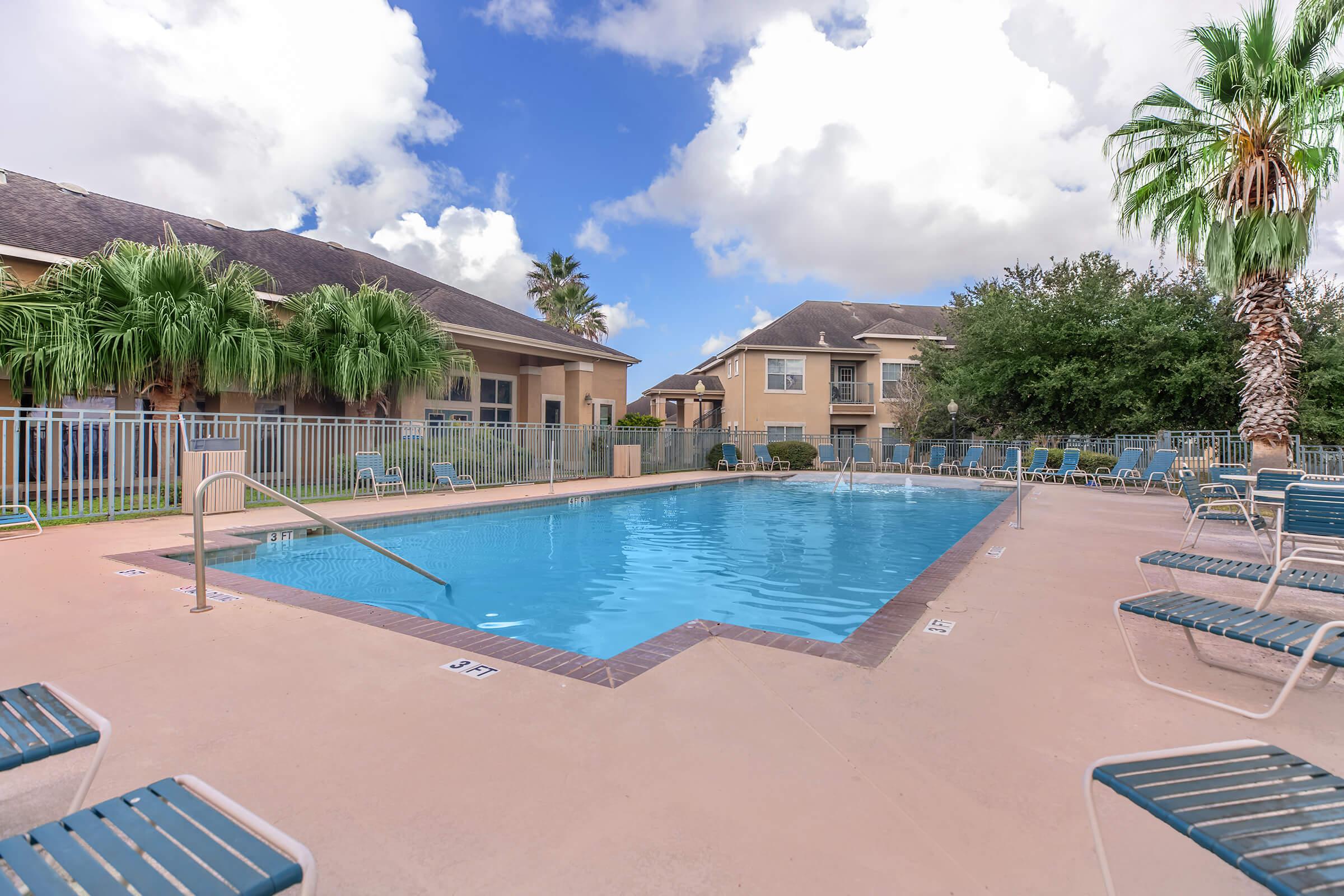 a group of lawn chairs sitting next to a pool