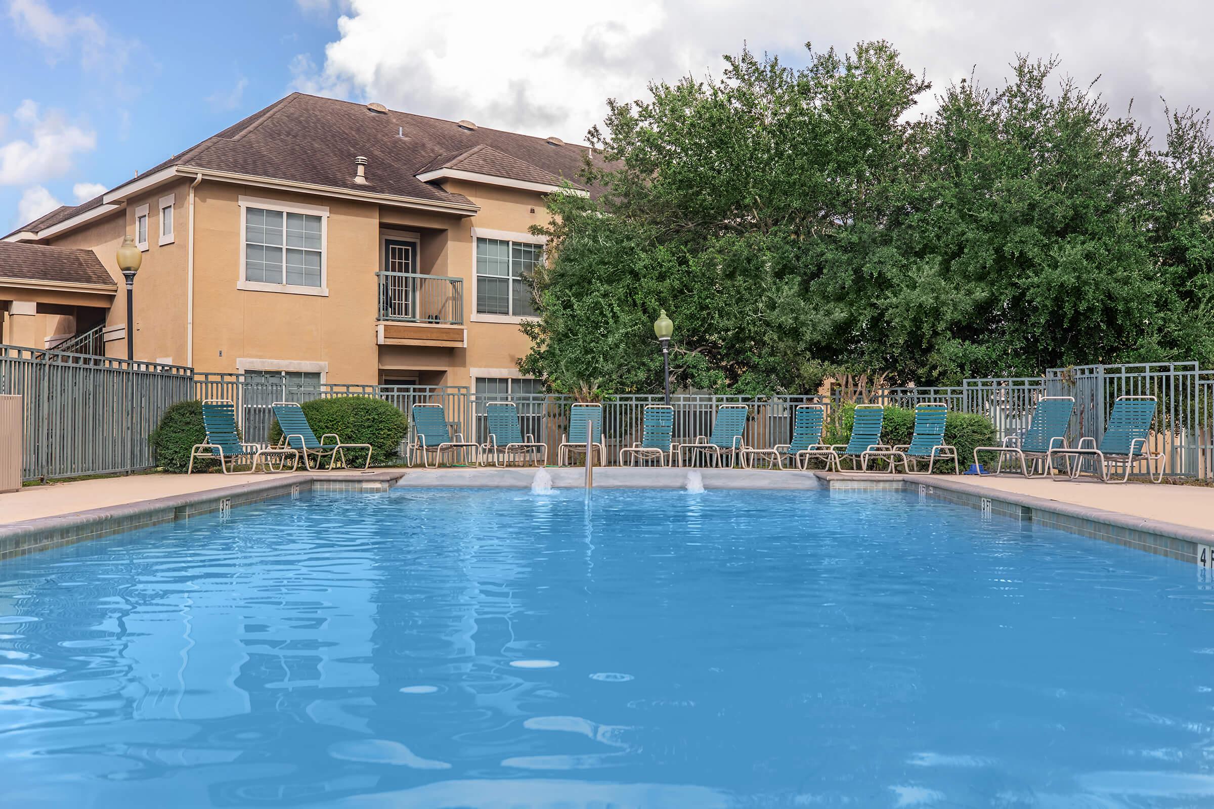 a large pool of water in front of a house