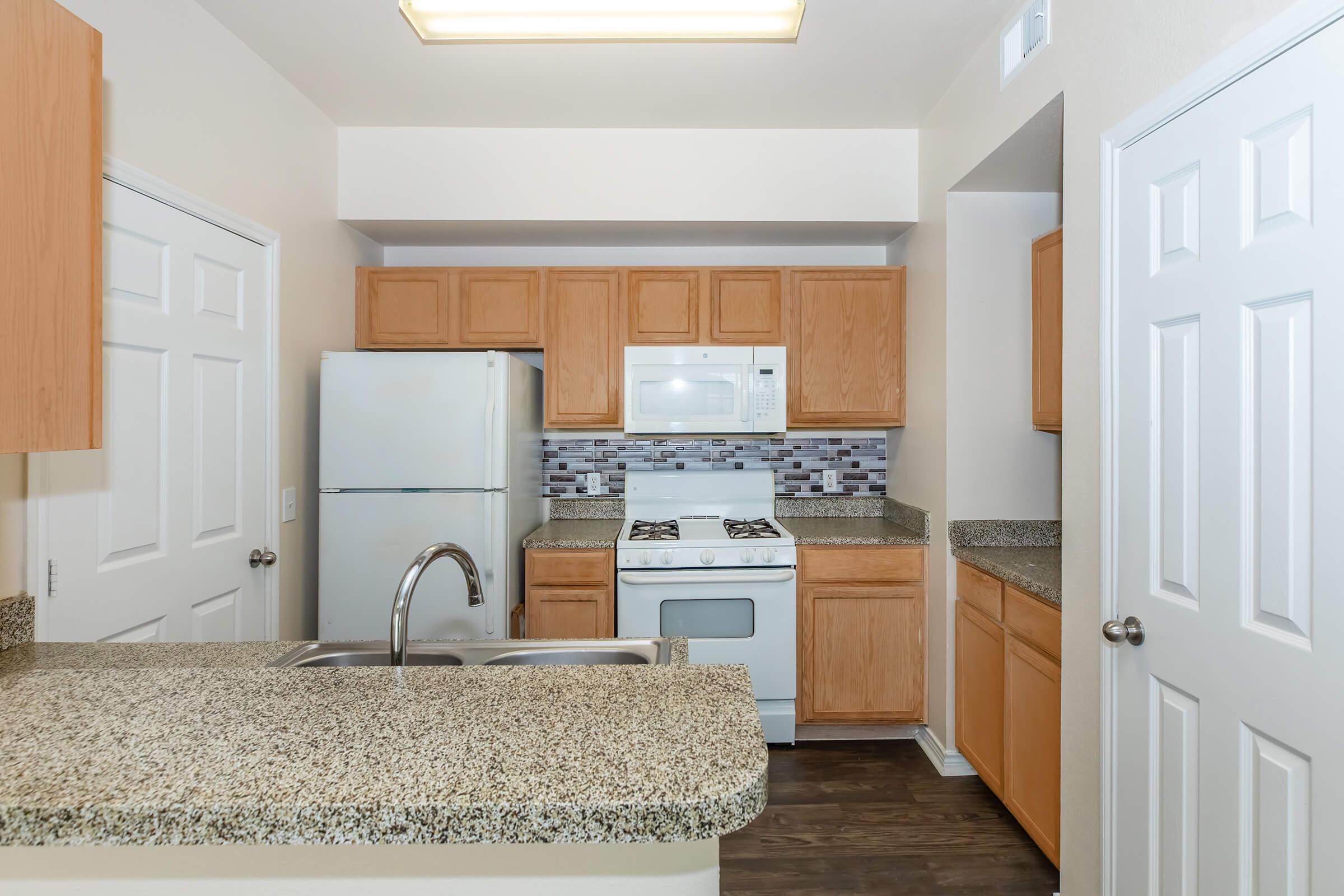 a kitchen with wooden cabinets