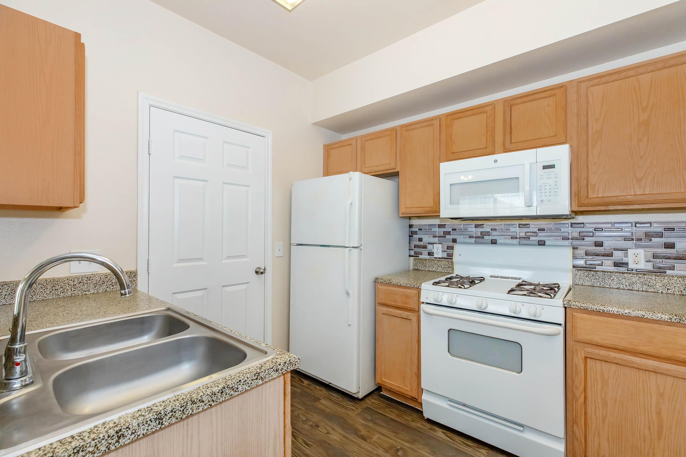 a stove top oven sitting inside of a kitchen