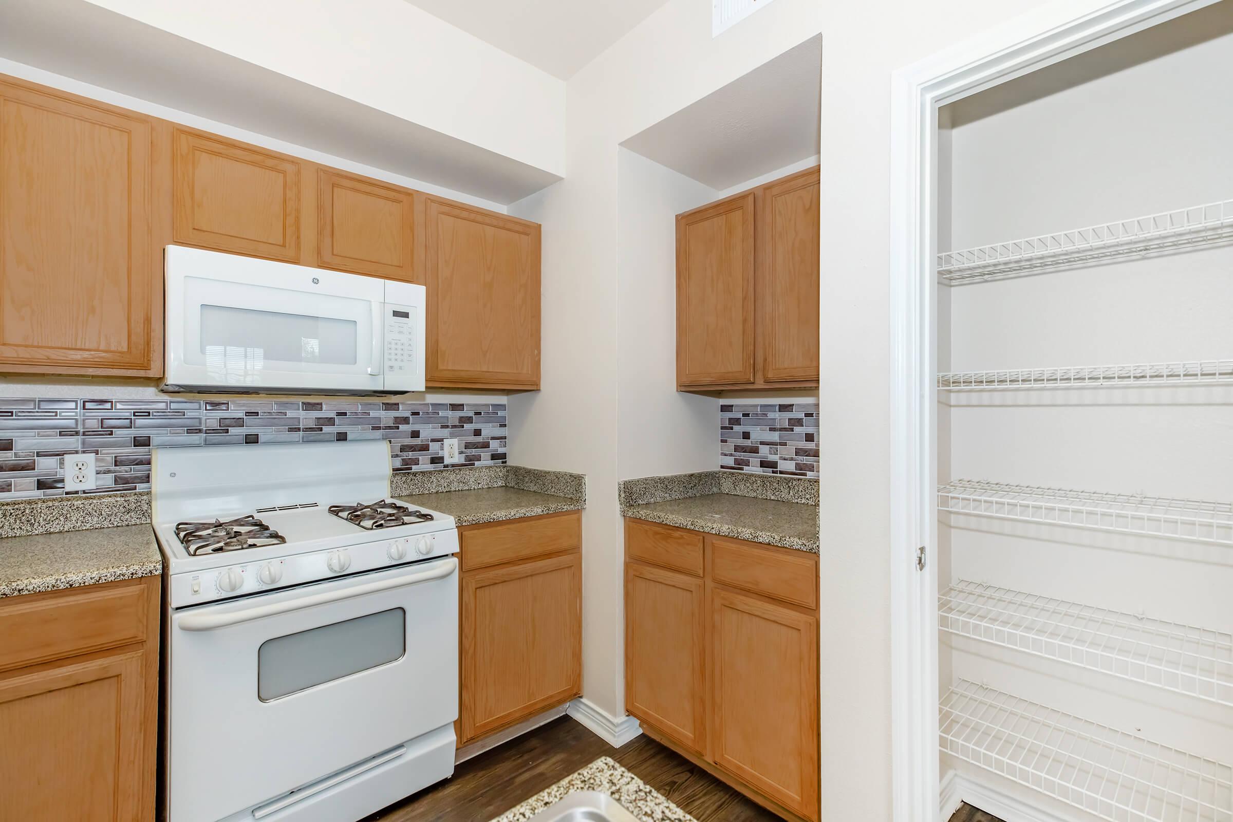 a stove top oven sitting inside of a kitchen