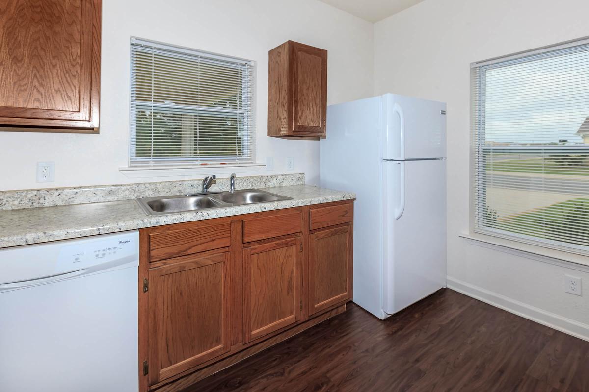 a kitchen with wooden cabinets and a window