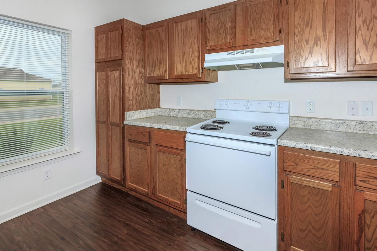 a kitchen with wooden cabinets and a microwave