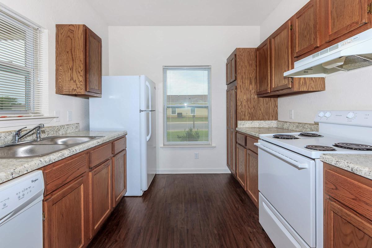 a kitchen with stainless steel appliances and wooden cabinets