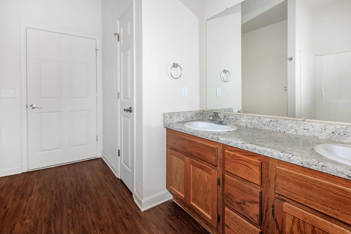 a kitchen with a sink and a mirror