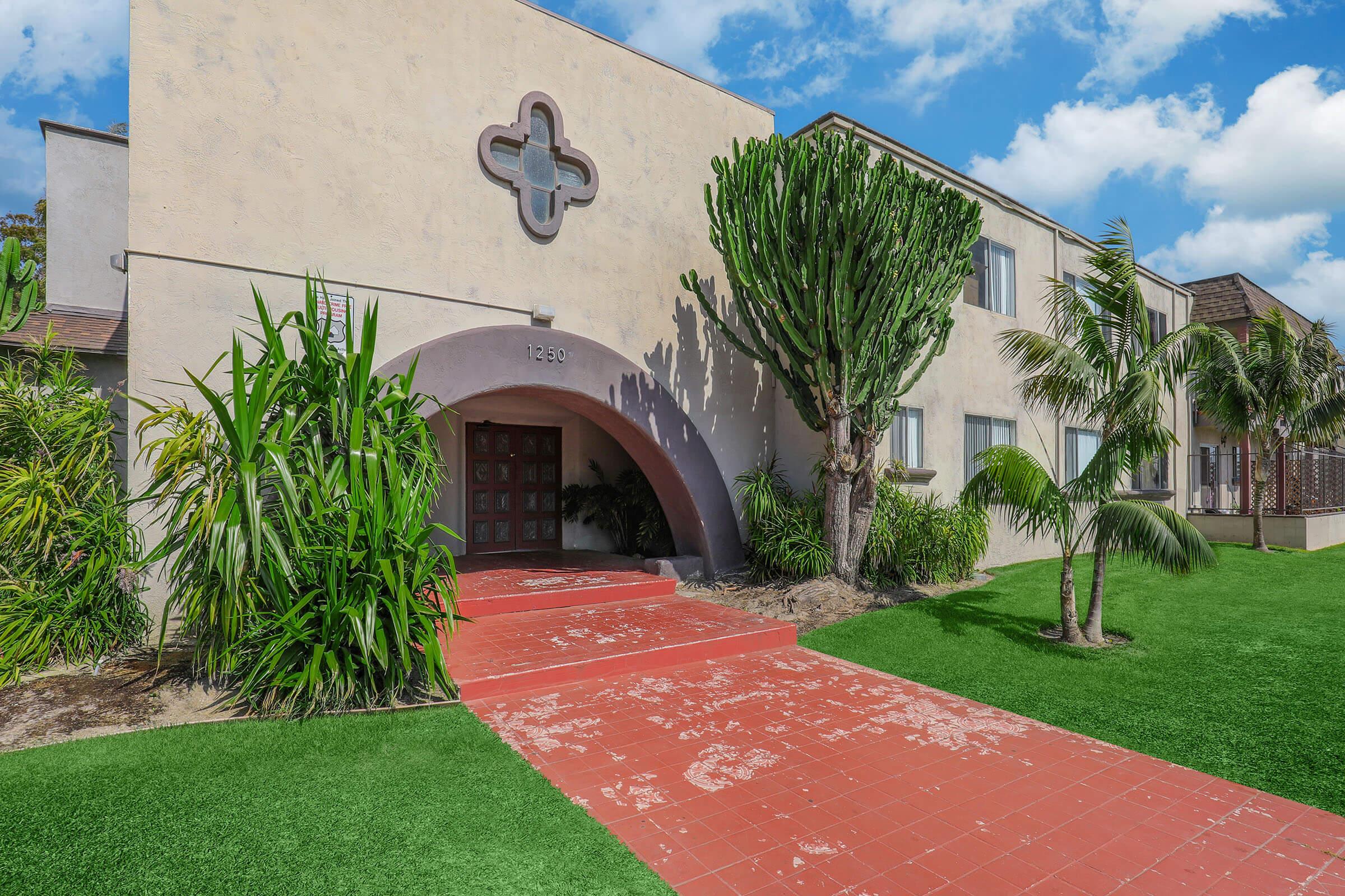 a large lawn in front of a brick building