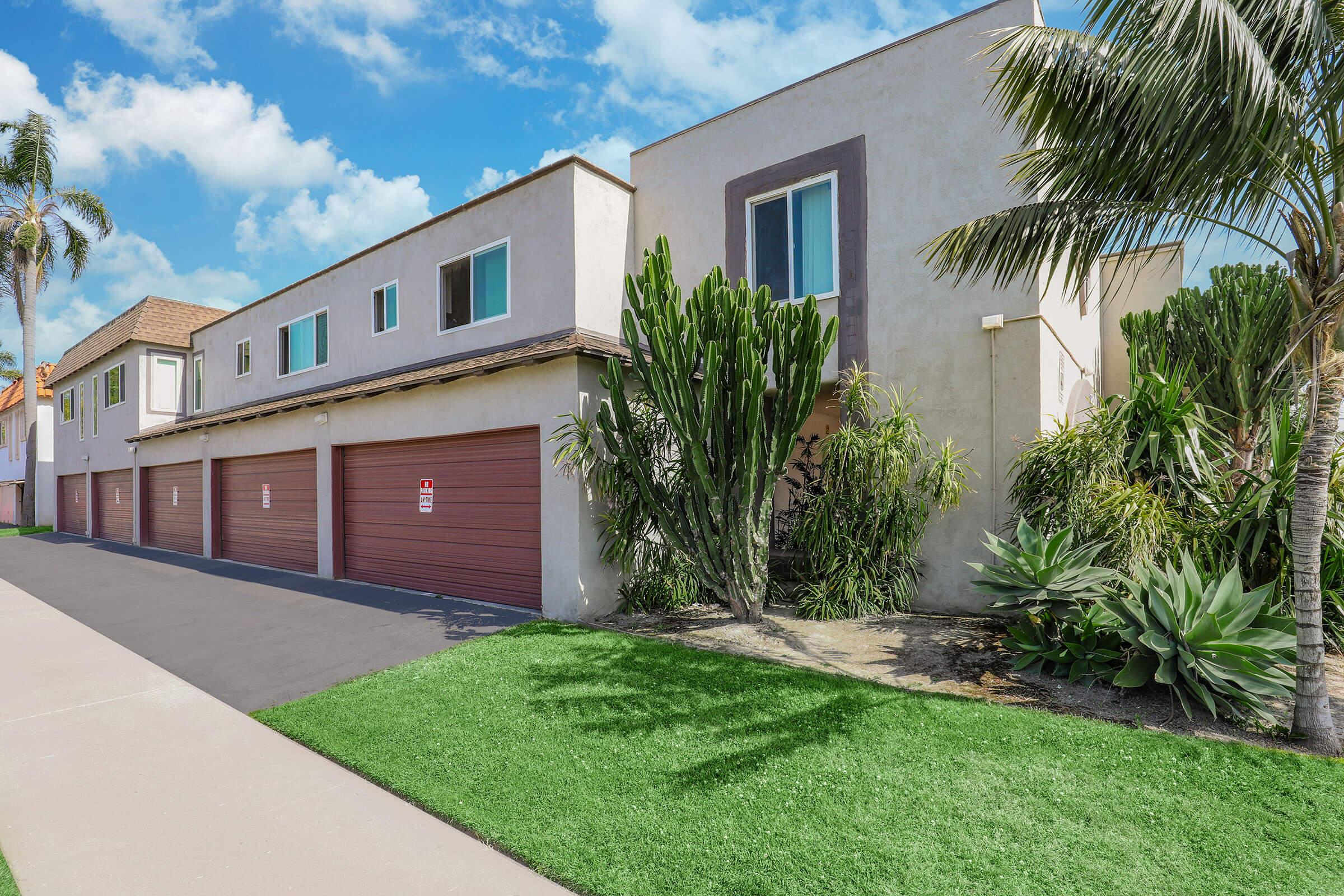 a large brick building with grass in front of a house