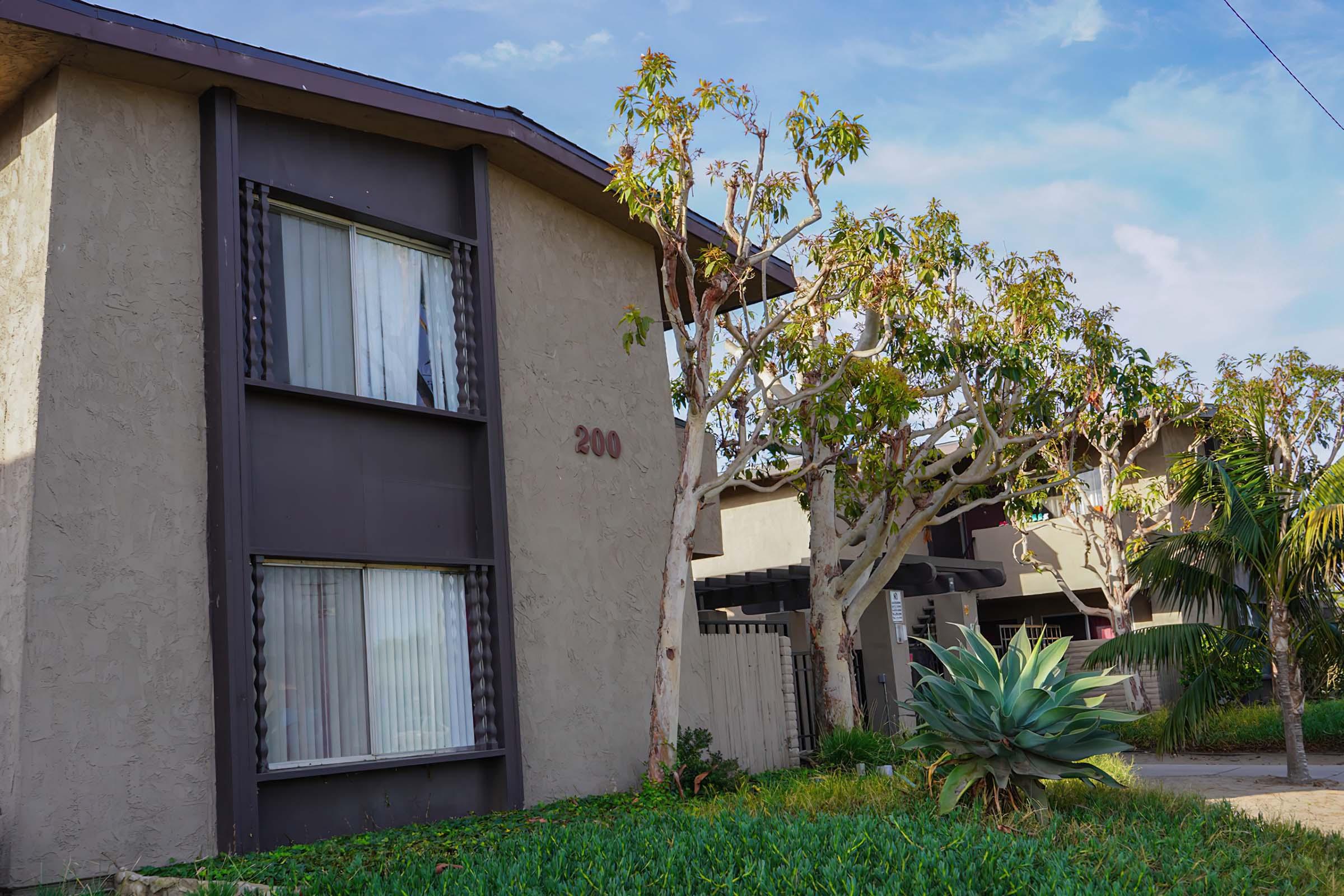 a house with bushes in front of a building