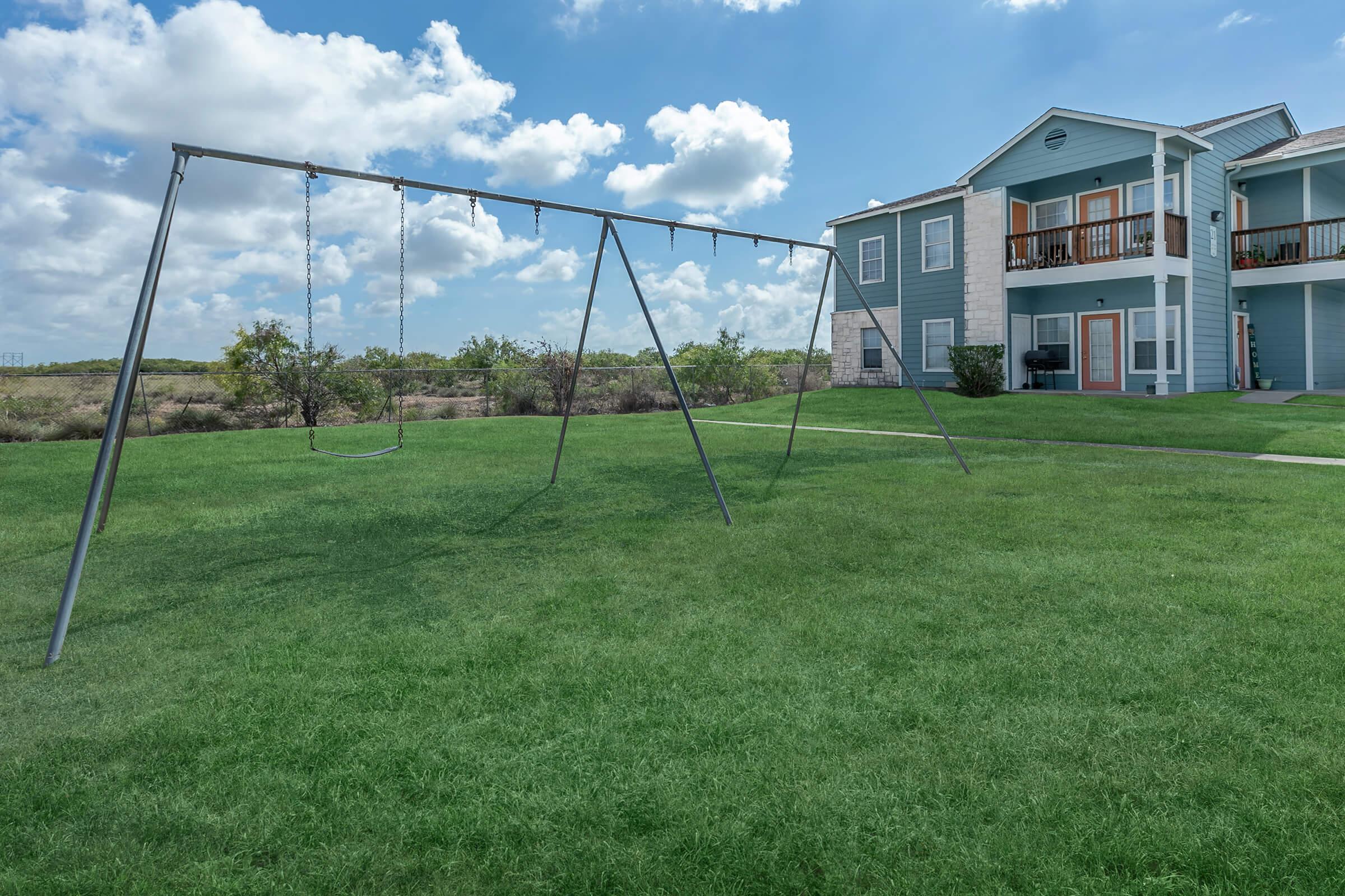 Greenspace, swing set and 2 story building Portside Villas Apts Ingleside, TX  78362