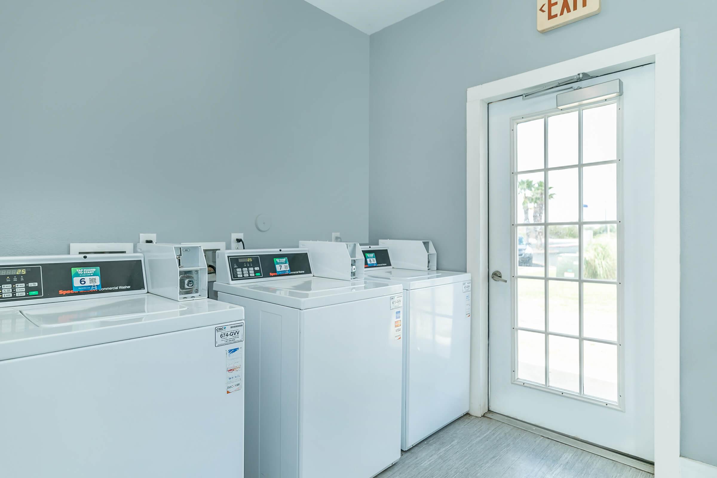 Community laundry room with washer and dryers Portside Villas Apts Ingleside TX