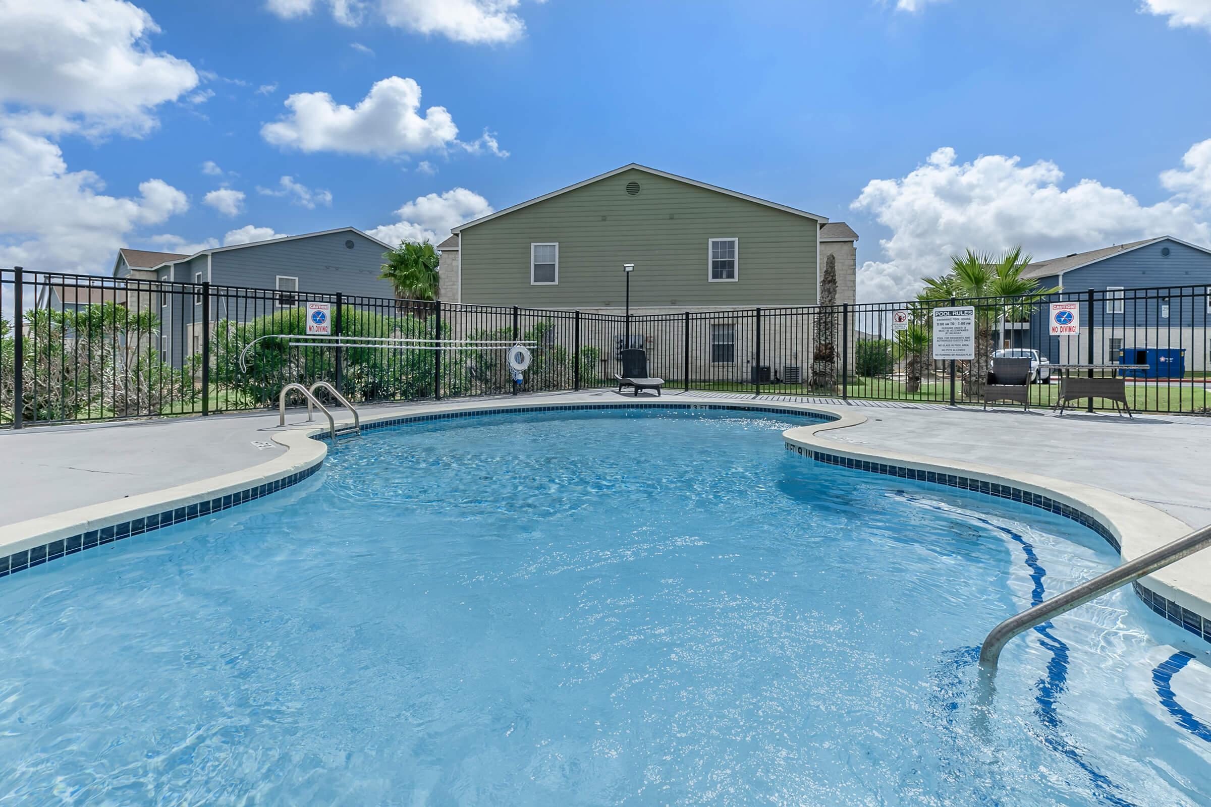 Pool area with sundeck fence and overlooking building Portside Villas Apts Ingleside, TX  78362