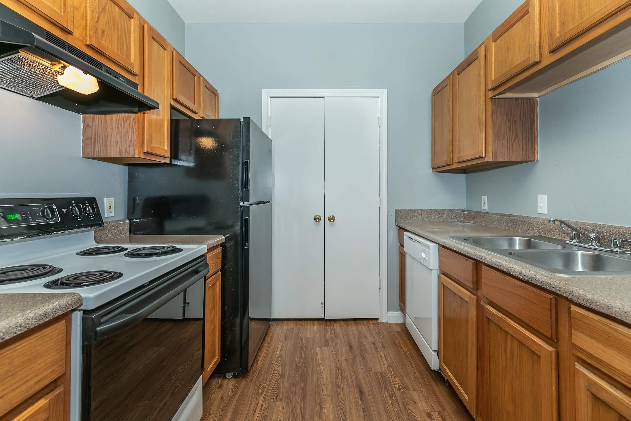 a kitchen with stainless steel appliances and wooden cabinets