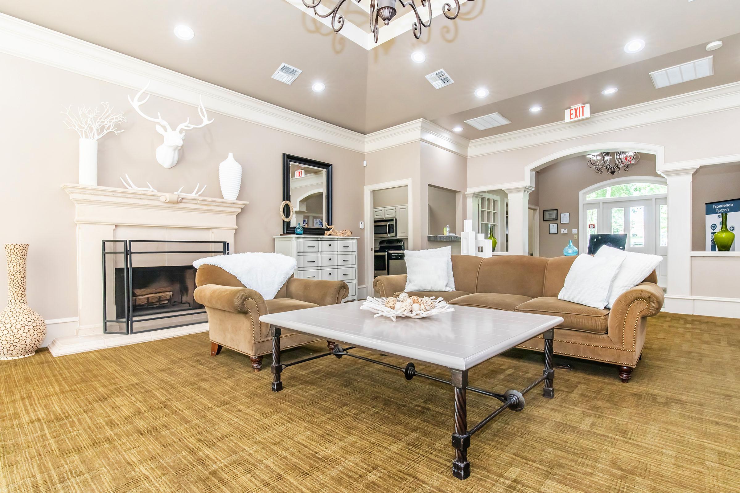 a living room filled with furniture and a large window