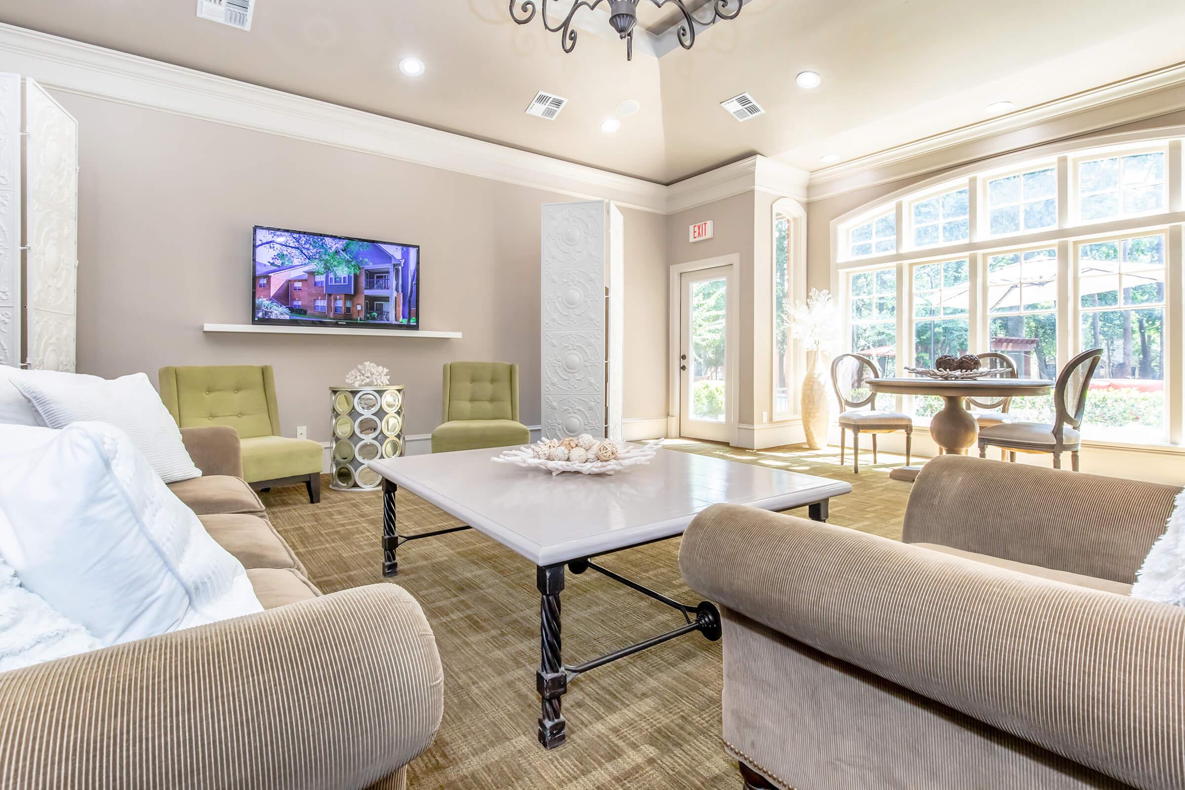 a living room with a bed and a window