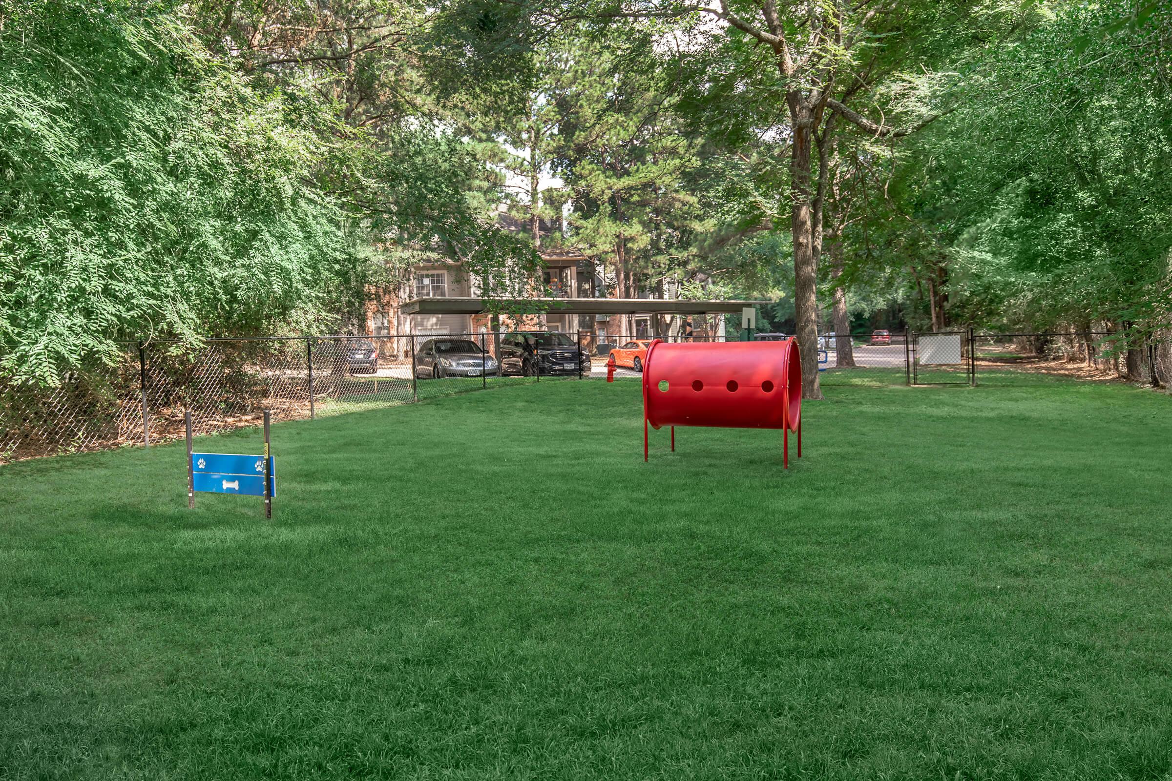 a group of lawn chairs sitting on top of a grass covered field