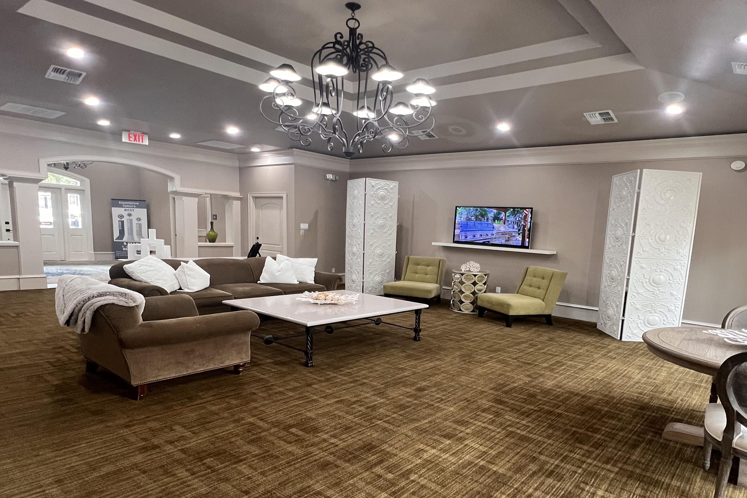 a living room filled with furniture and a large window