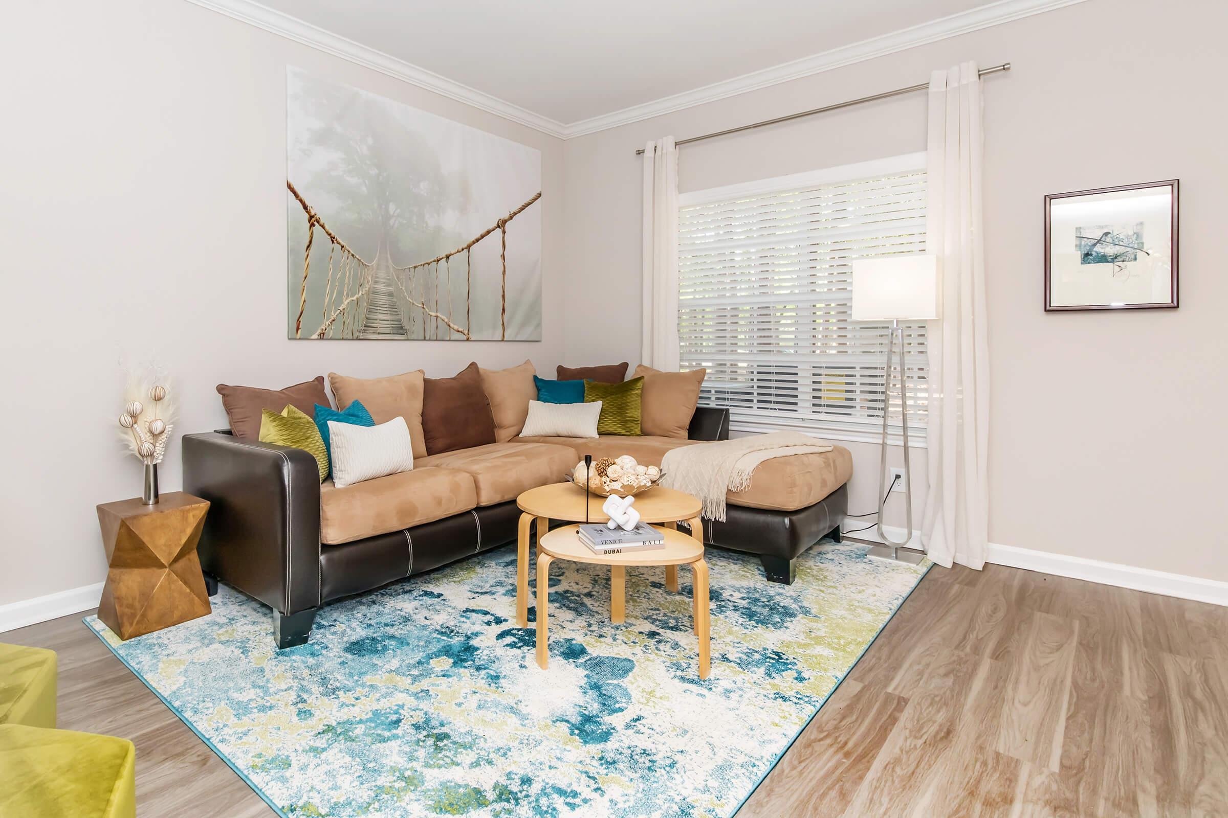 a living room filled with furniture and a flat screen tv