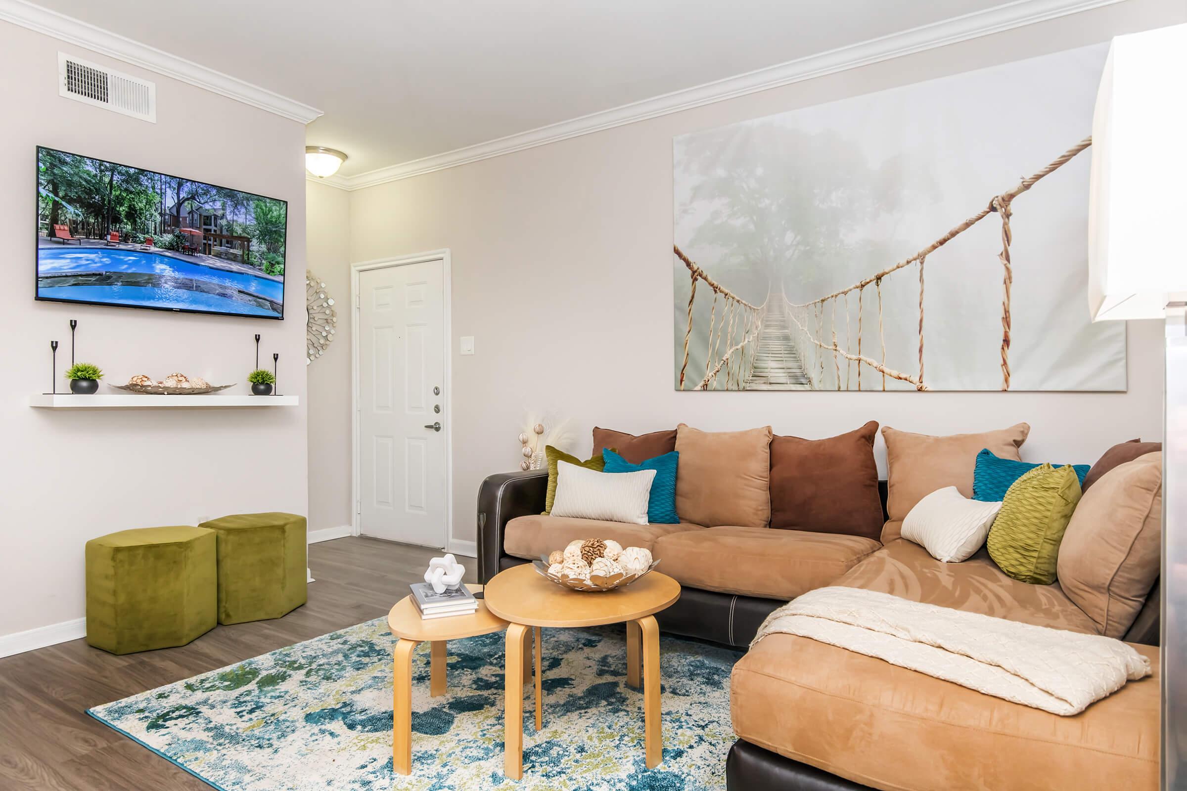 a living room filled with furniture and a flat screen tv