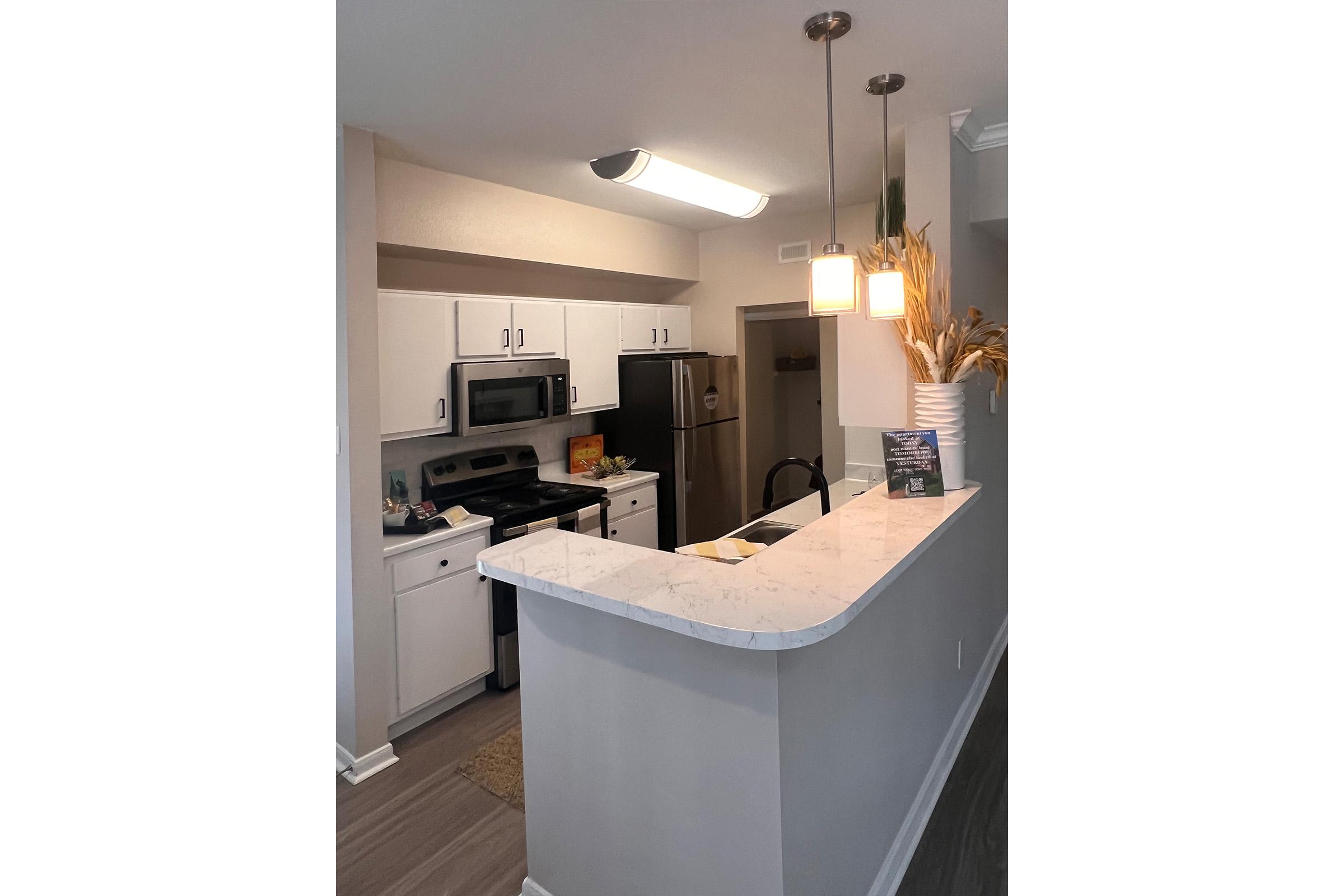 a kitchen with a sink and a mirror