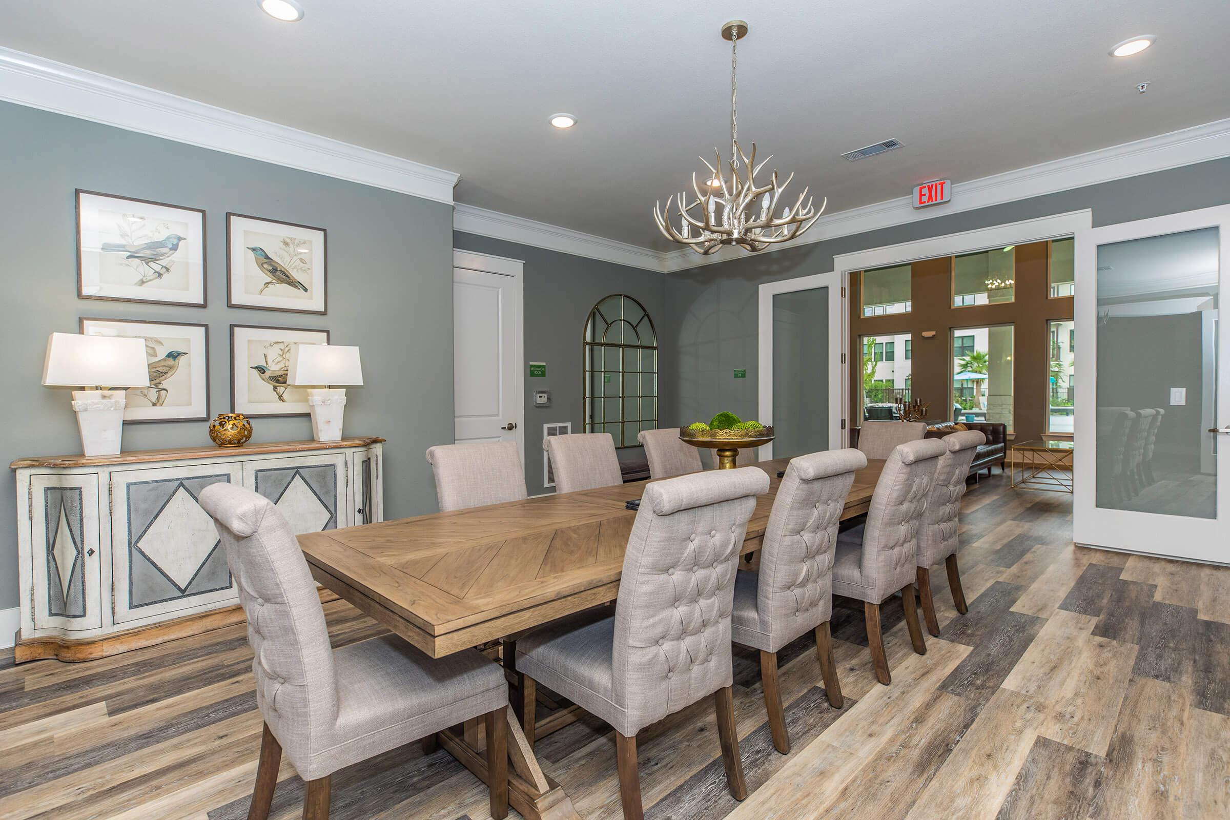 meeting room at ivy point kingwood senior living apartments featuring a large table surrounded by chairs