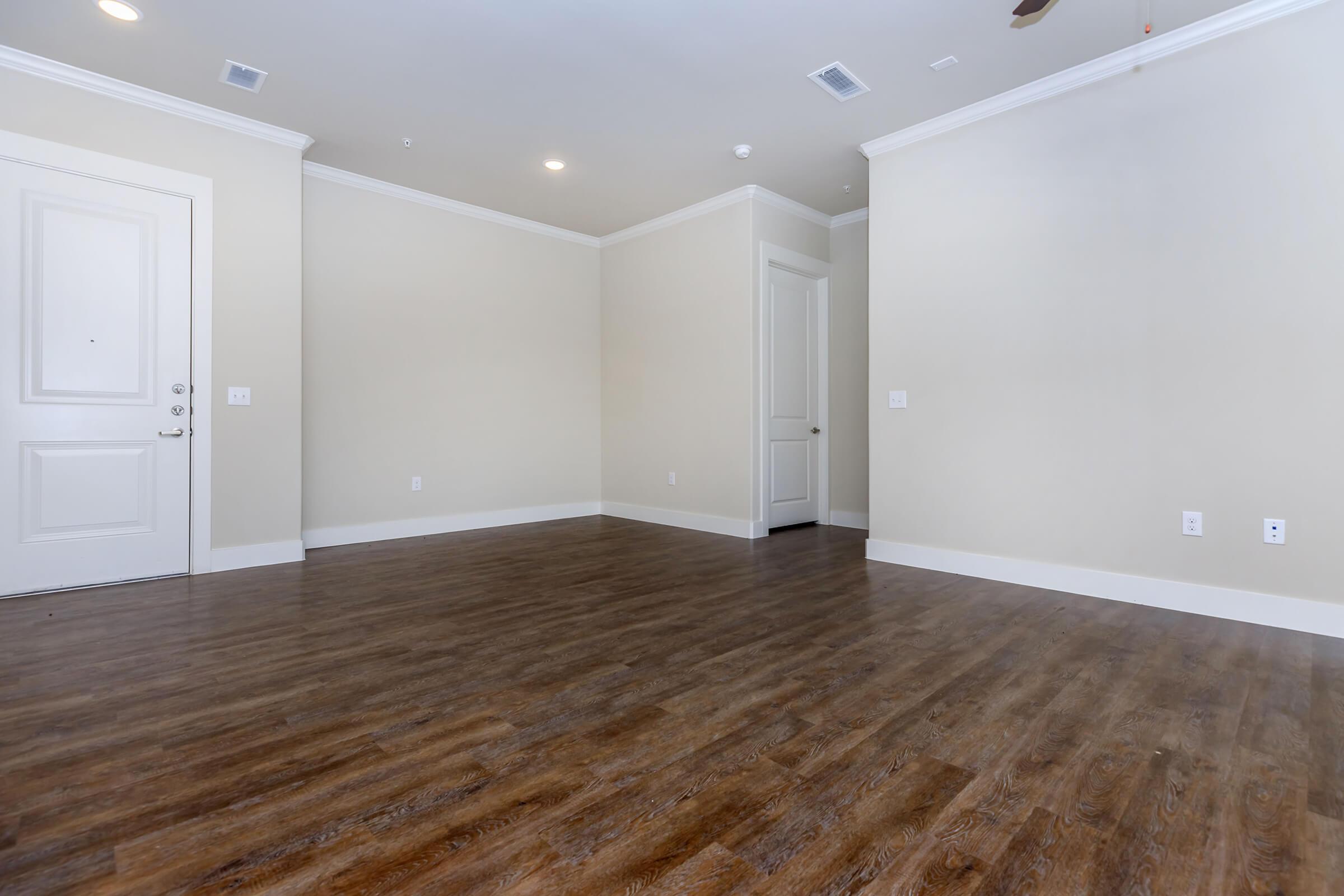 bedroom at ivy point kingwood senior living apartments in kingwood tx featuring wood grain flooring and beige wals