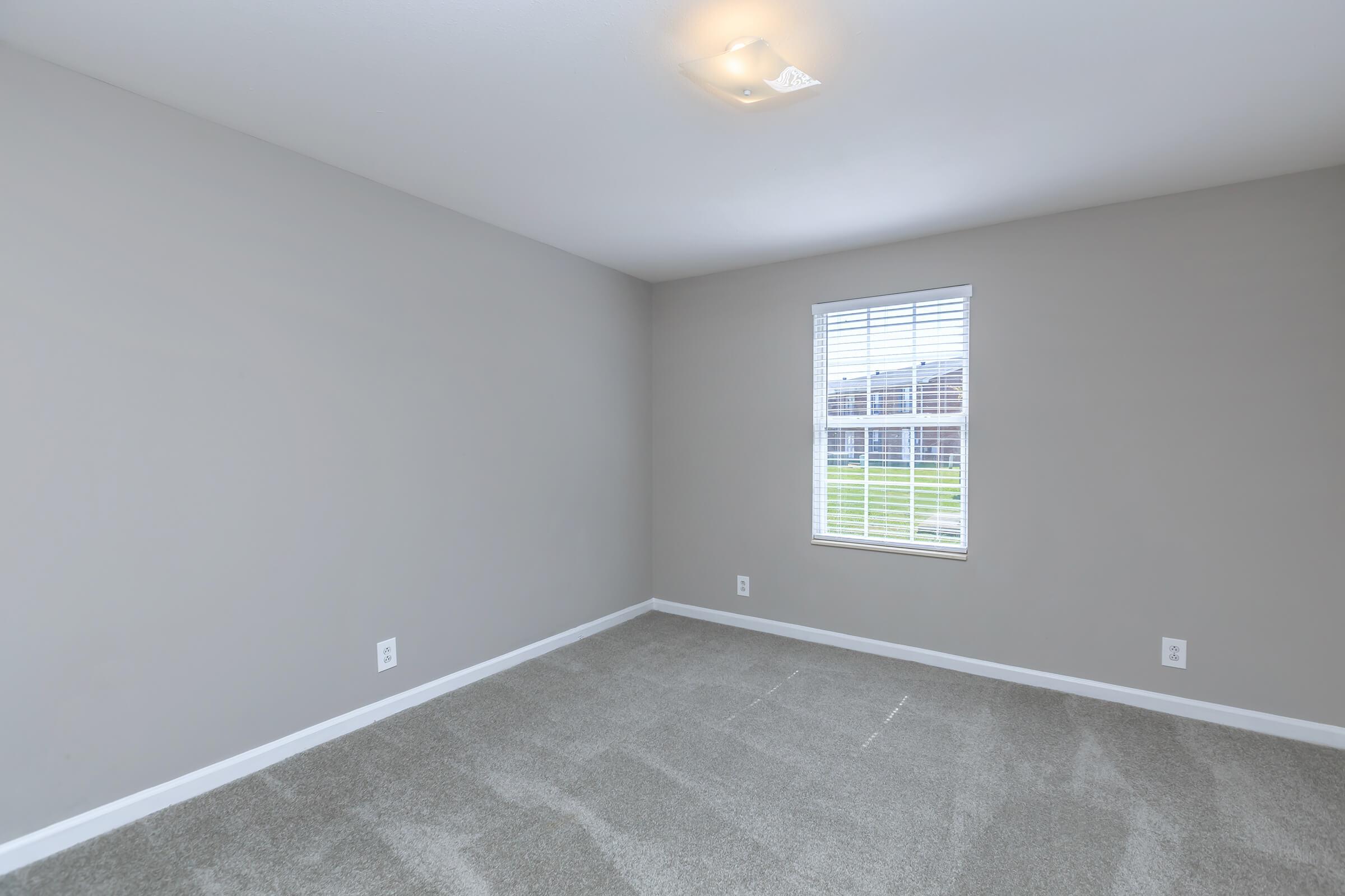 a bedroom with a bed in a room
