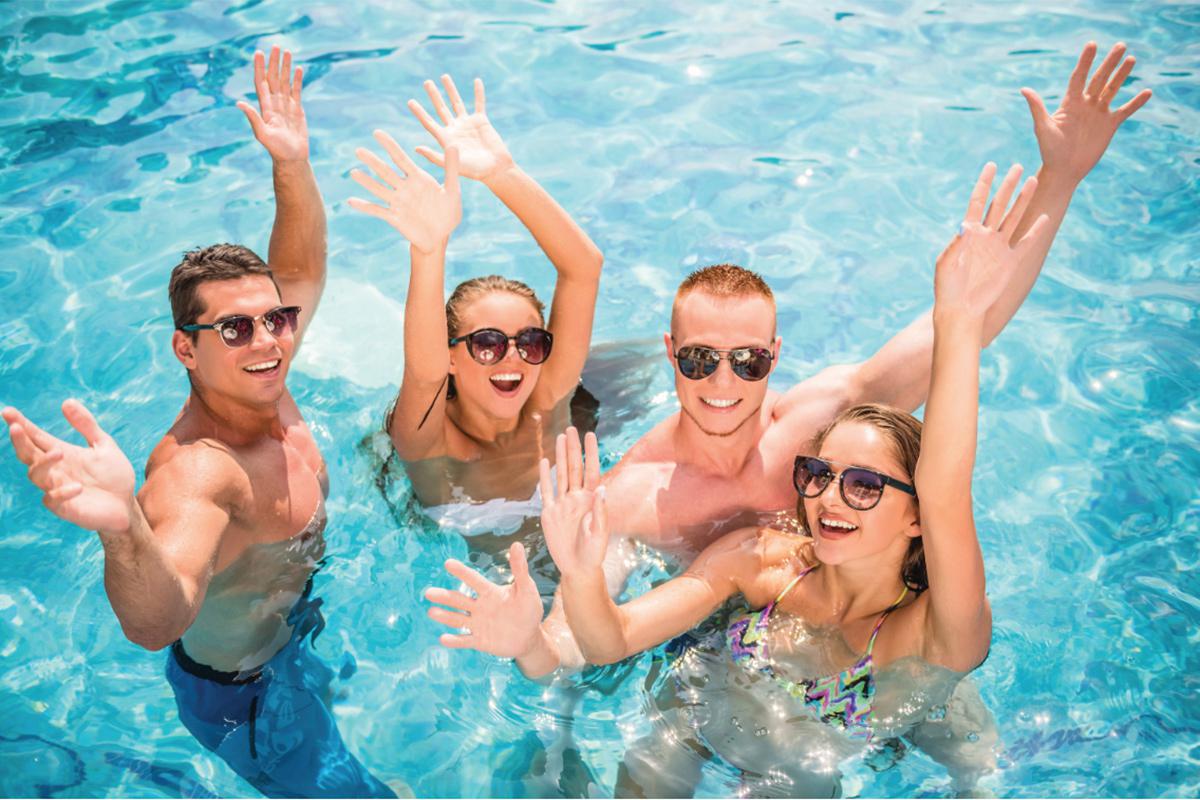a group of people swimming in a pool of water