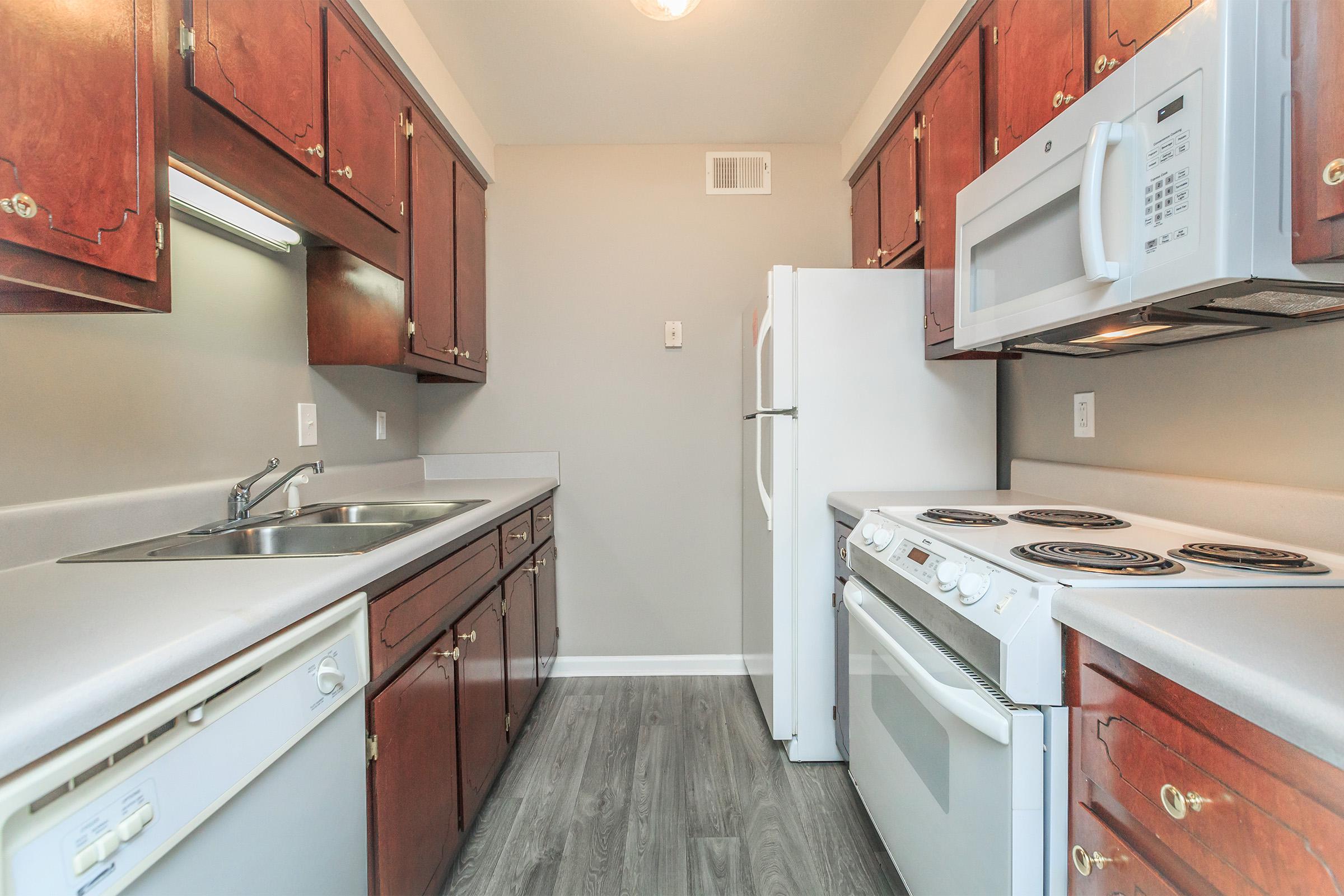 a kitchen with a stove sink and refrigerator
