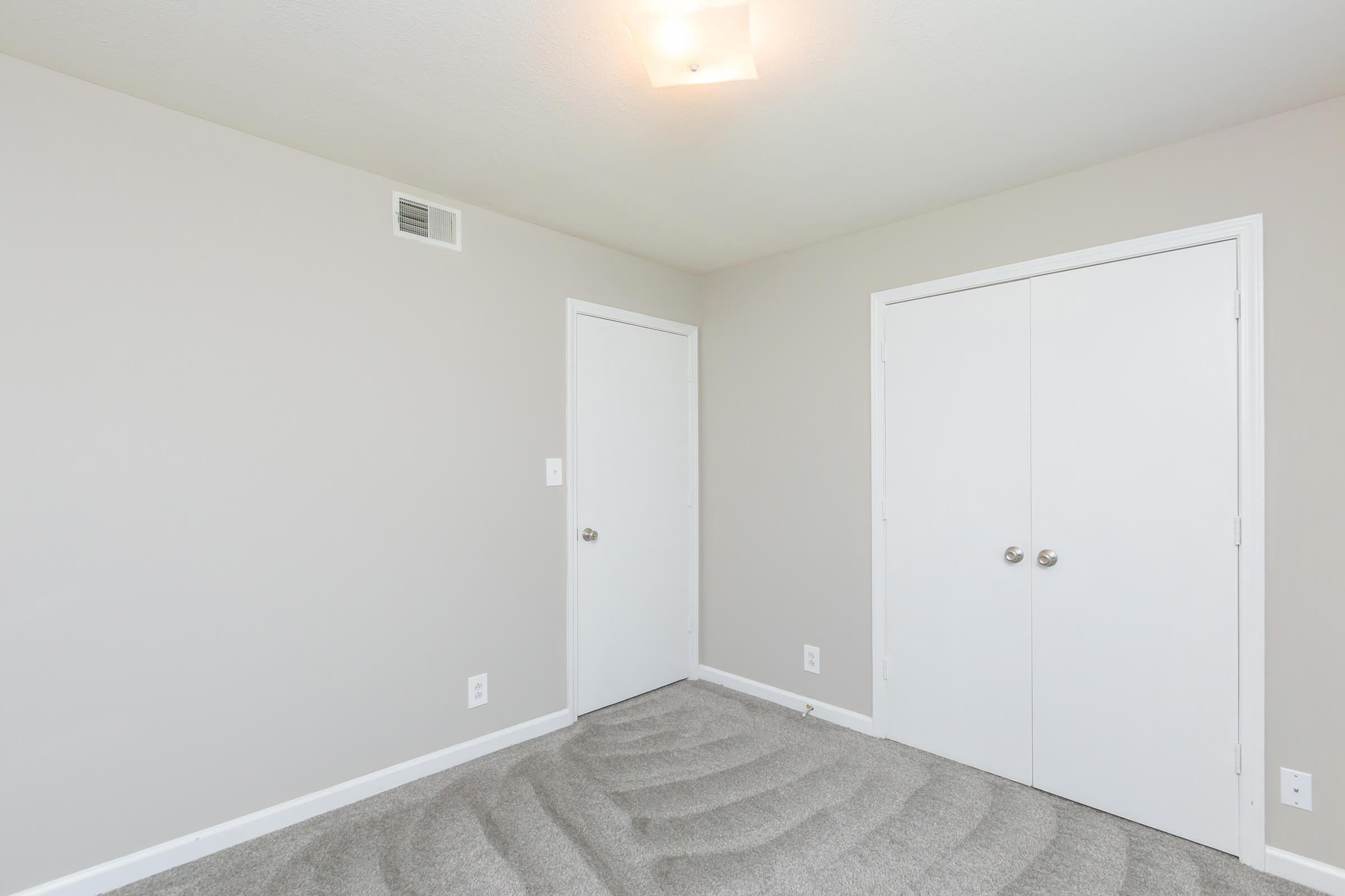 a bedroom with a large mirror