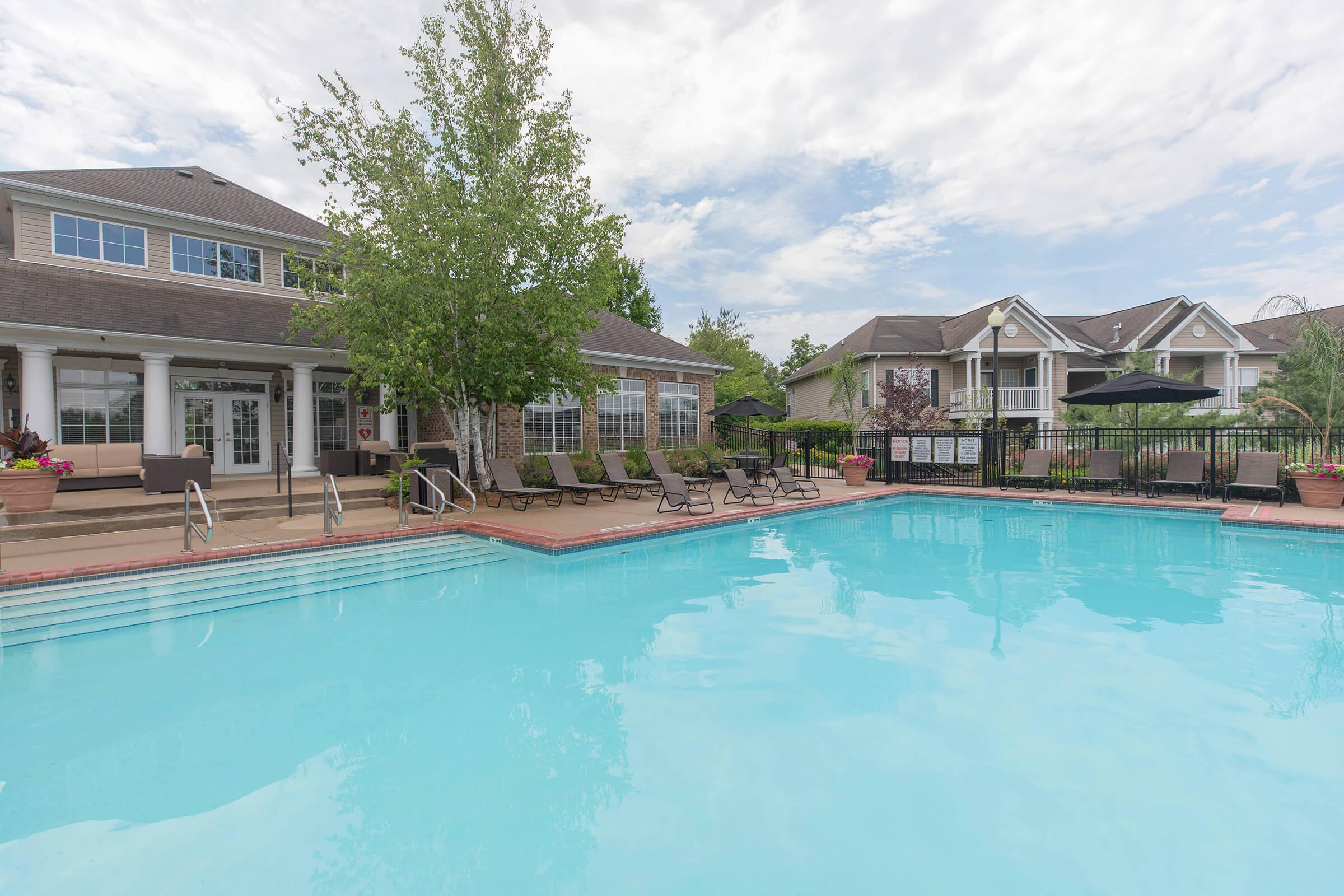 a large pool of water in front of a house