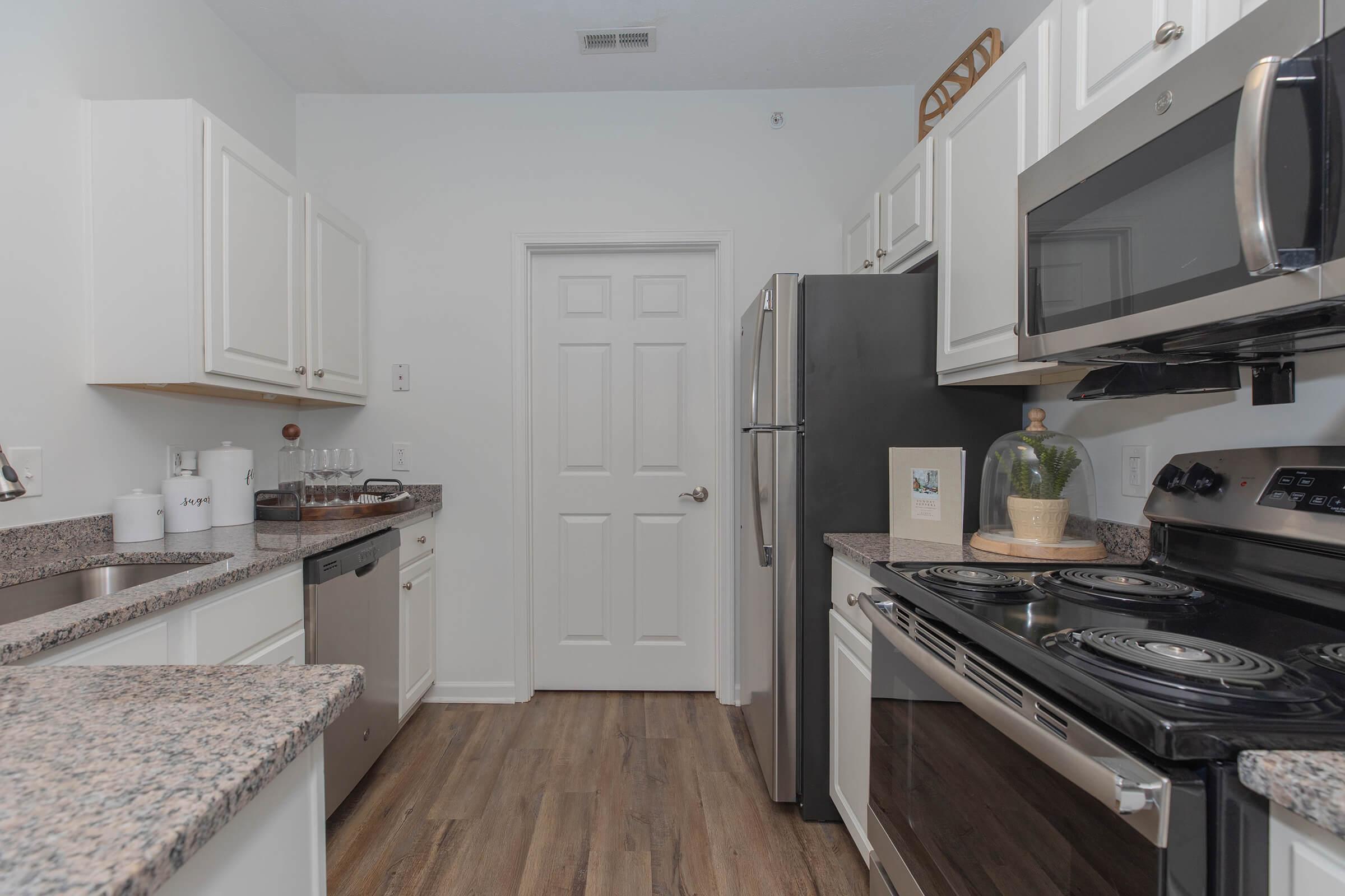 a stove top oven sitting inside of a kitchen