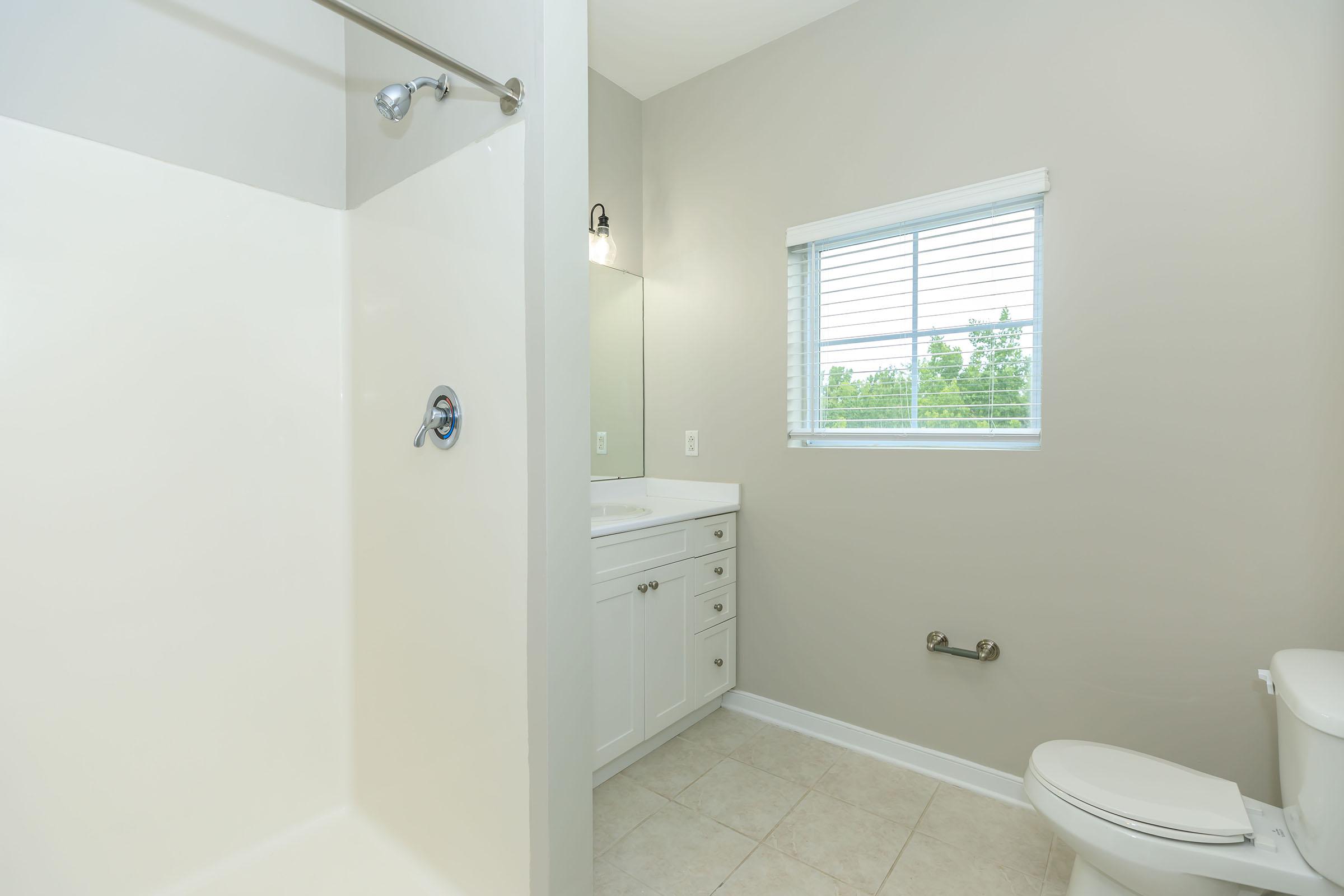 a room with a sink and a shower