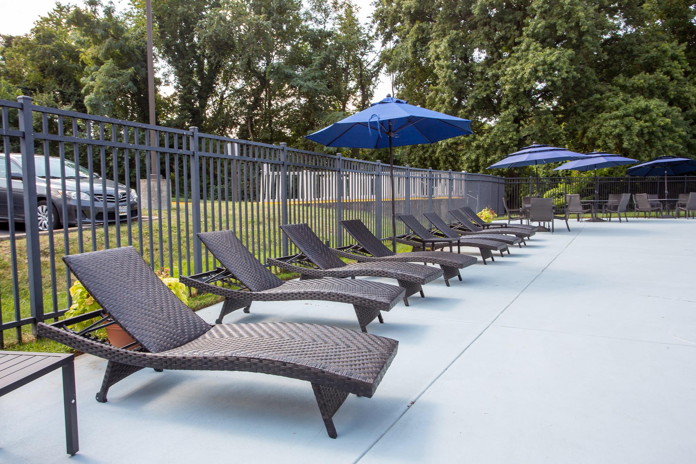 a couple of lawn chairs sitting on top of a wooden fence