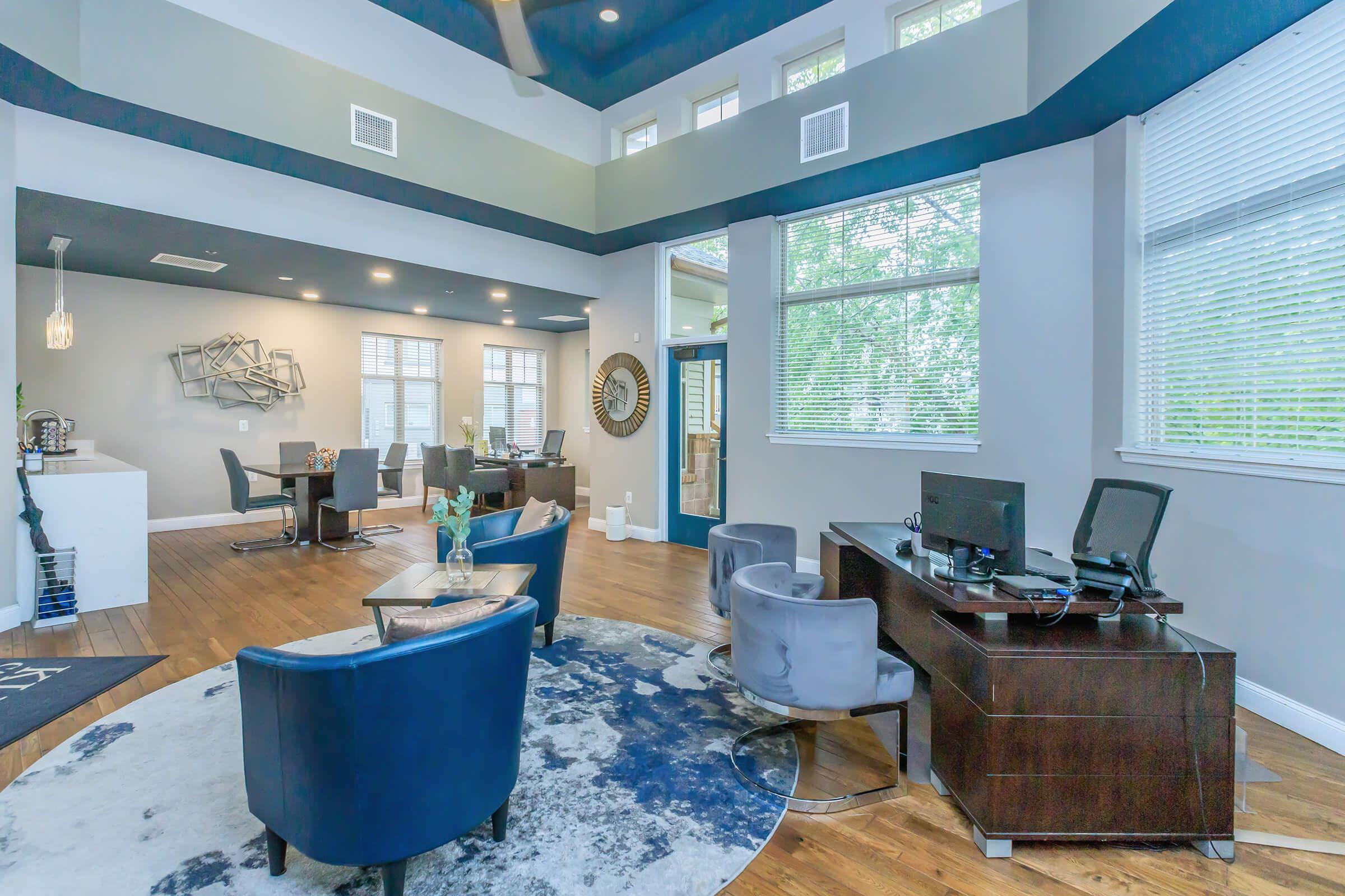 a living room filled with furniture and a large window