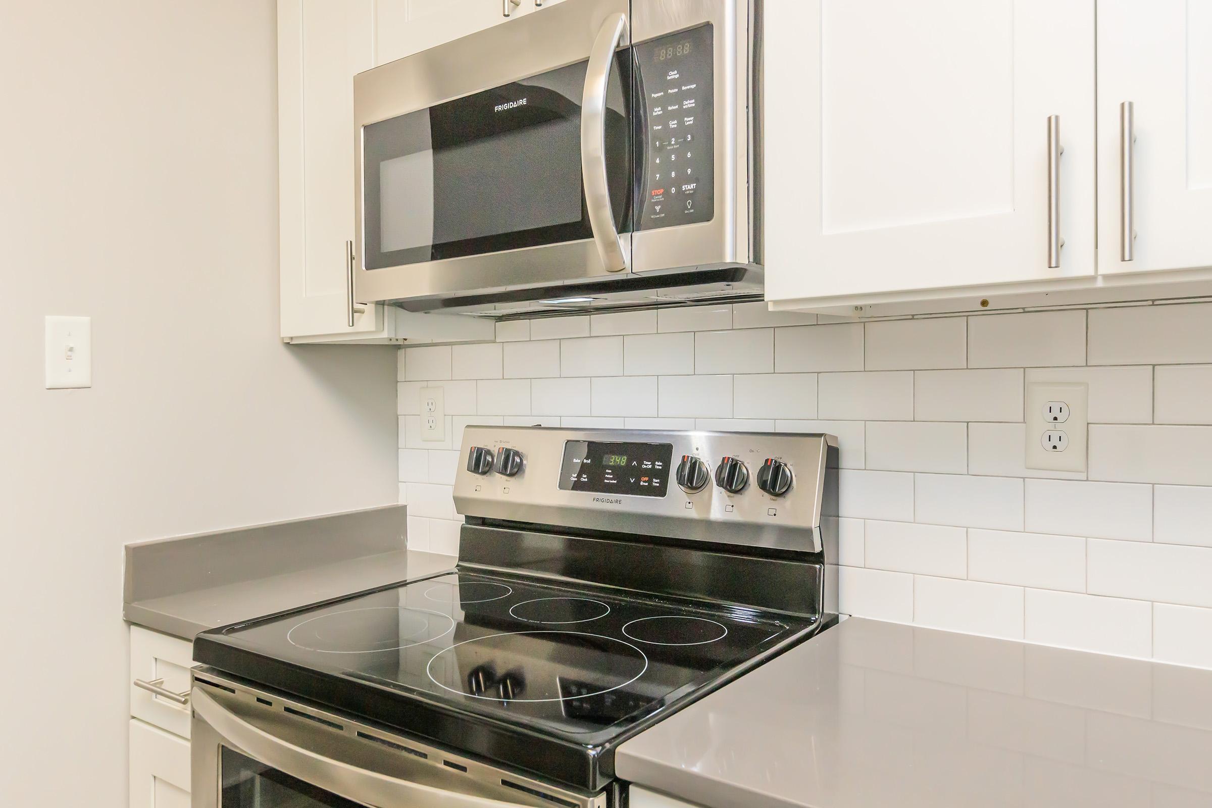 a stove top oven sitting inside of a kitchen