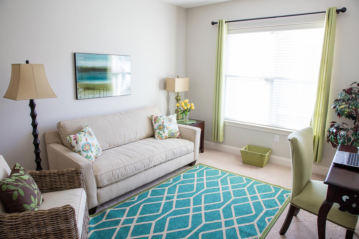 a living room filled with furniture and a window