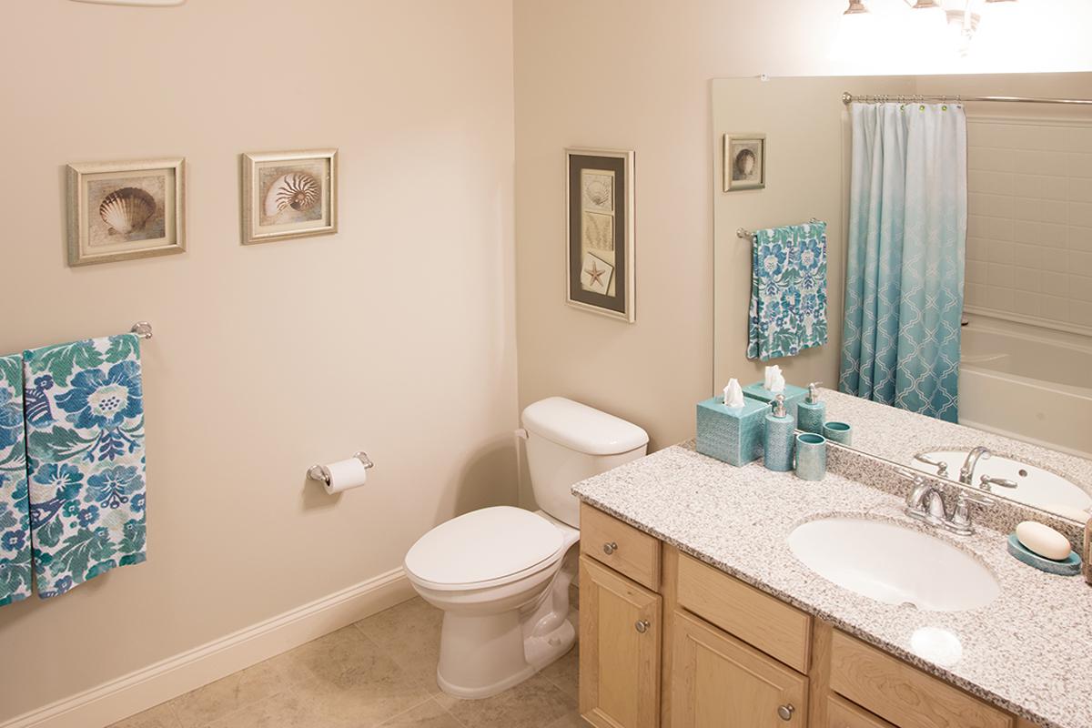 a bedroom area with a sink and a mirror