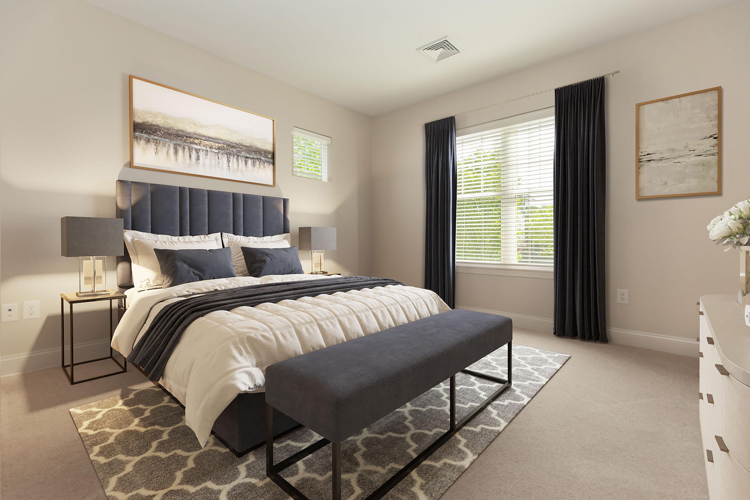 a bedroom with a bed and desk in a hotel room