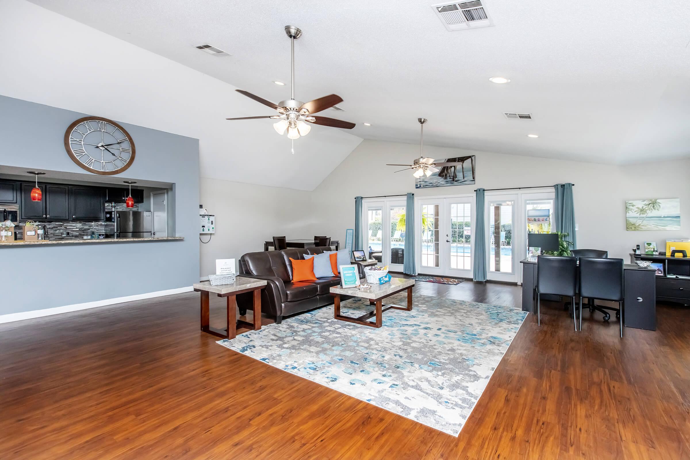 a living room filled with furniture on top of a hard wood floor