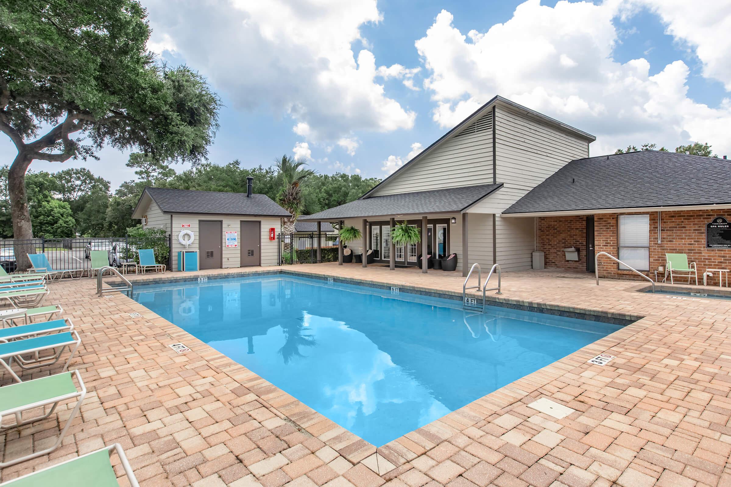 a house with a pool outside of a building