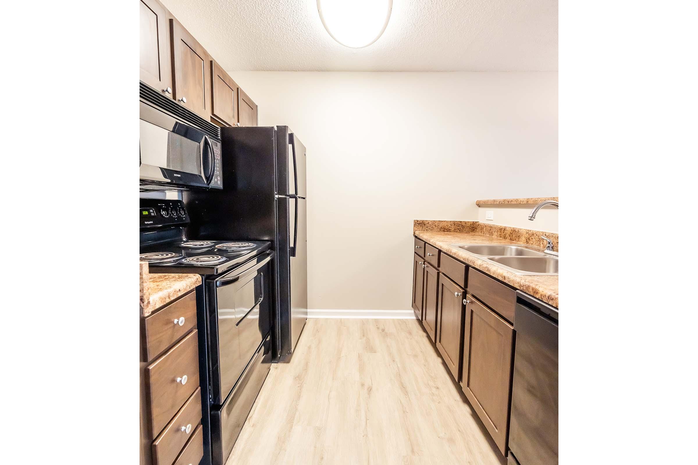 a kitchen with stainless steel appliances and wooden cabinets