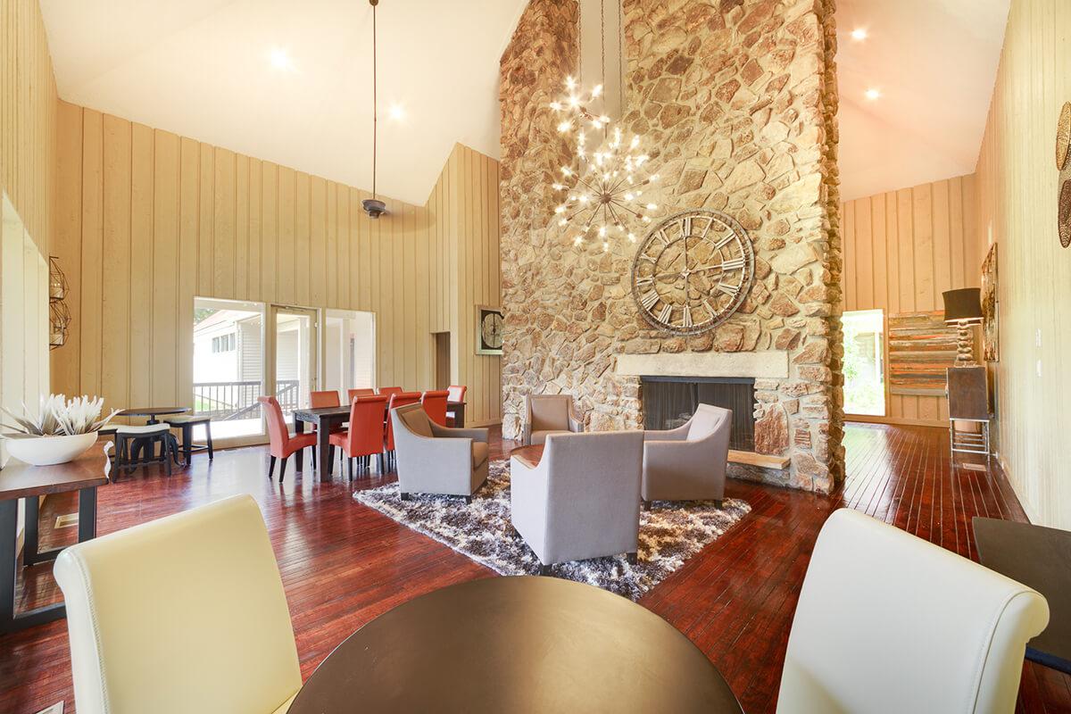 a living room filled with furniture and a fire place and a dining table