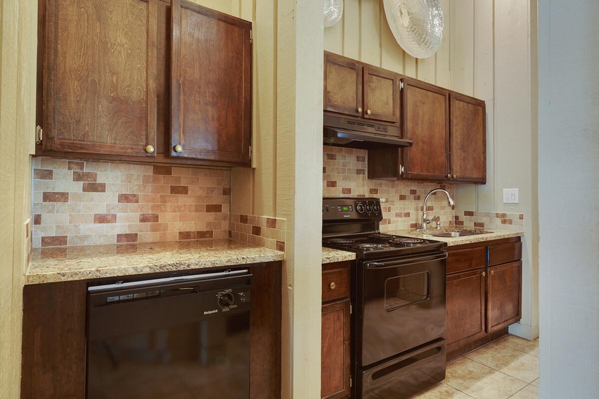 a stove top oven sitting inside of a kitchen