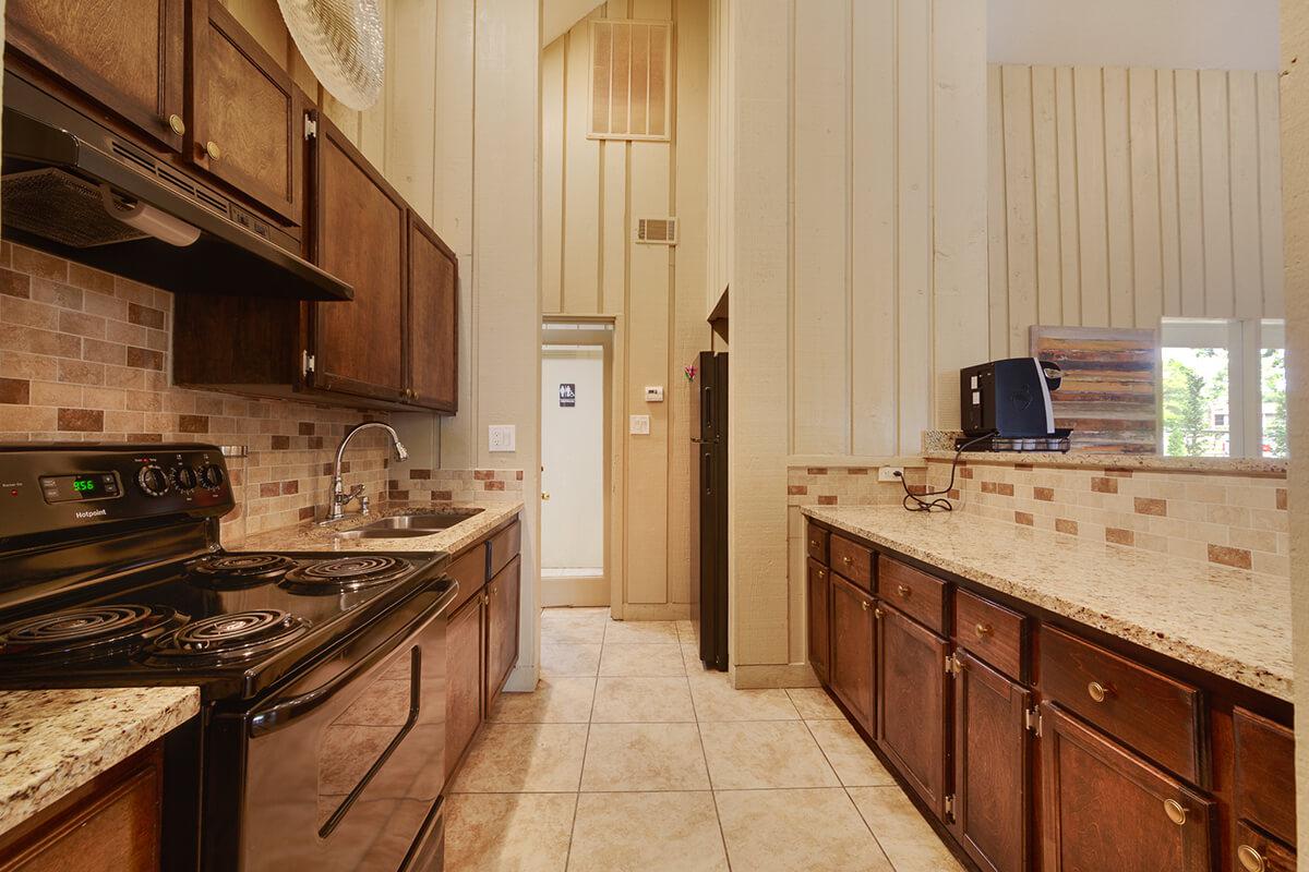 a kitchen with a stove top oven sitting inside of a building