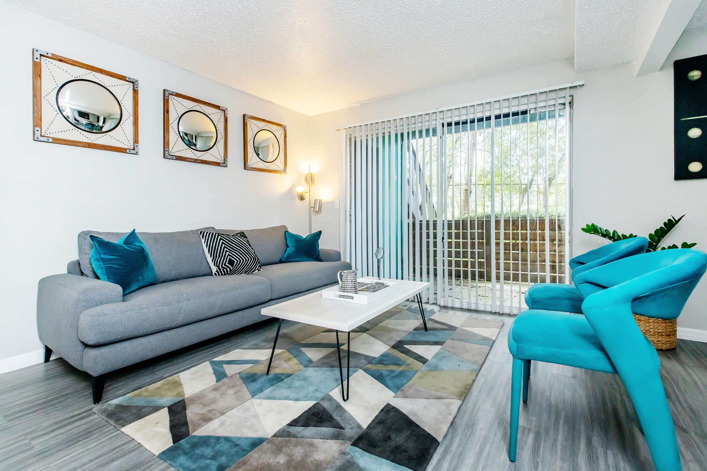 a living room filled with furniture and a blue chair